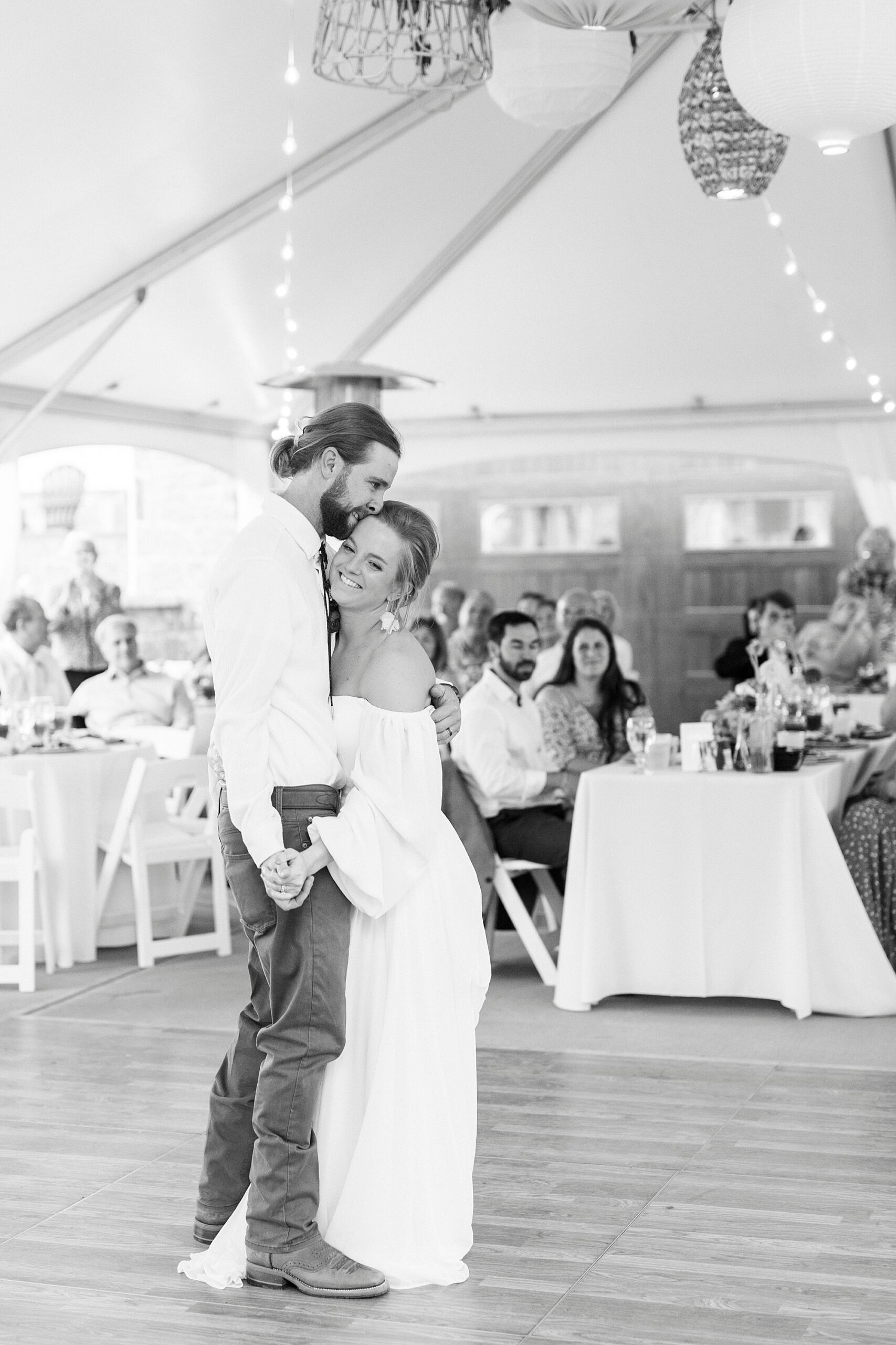 bride and groom grin dancing together during wedding reception on lawn in Richfield NC