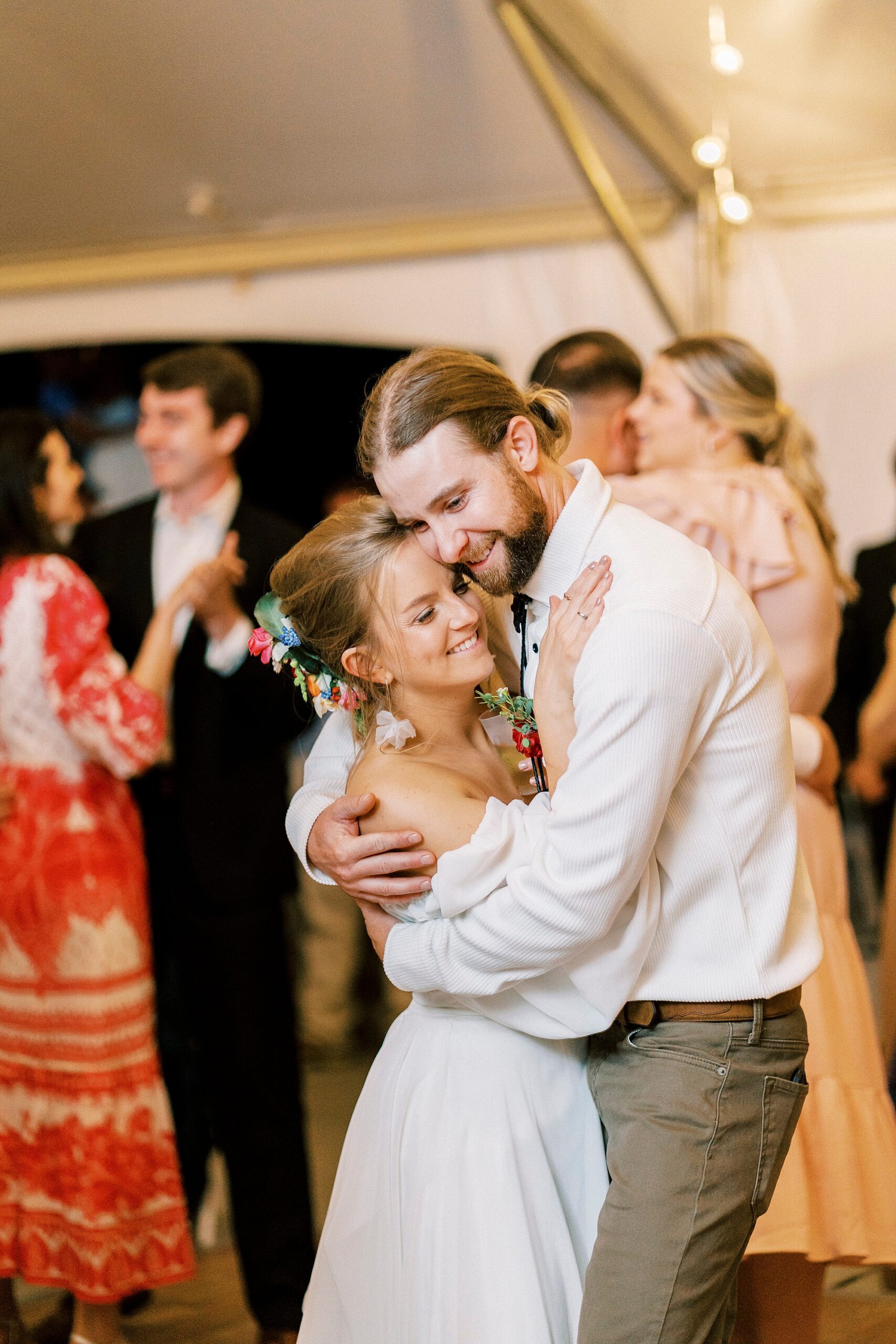 groom hugs bride to him on dance floor during wedding reception on lawn in Richfield NC