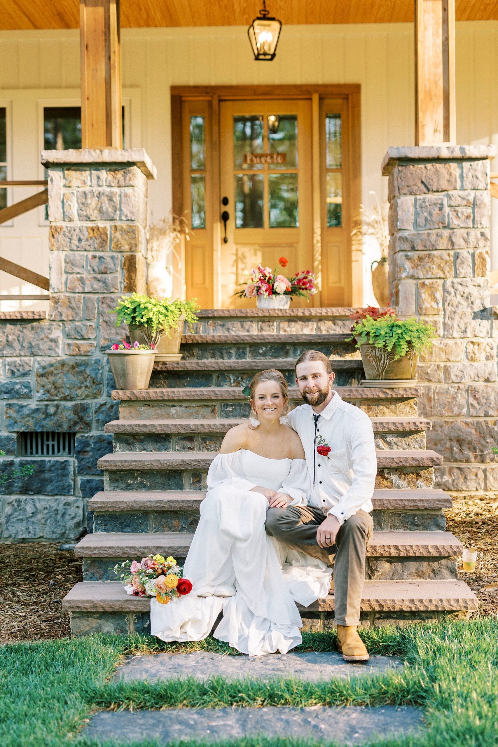 bride and groom sit on front steps of home in Richfield NC