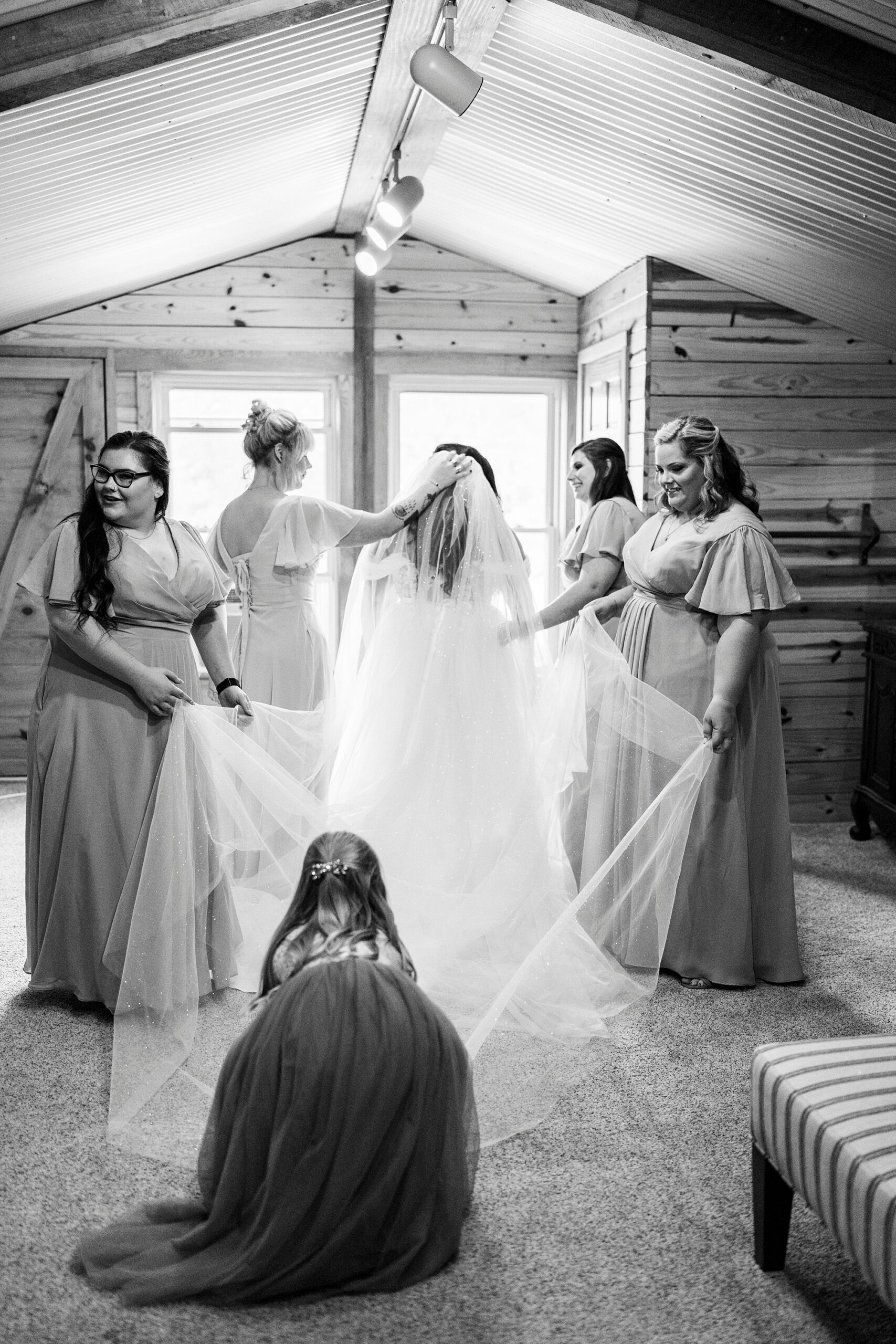 bridesmaids place veil for bride during prep at Danner Farms