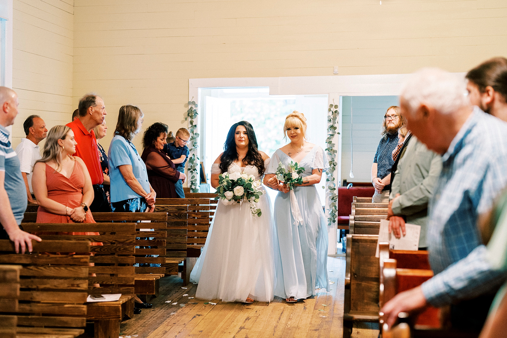 bride enters wedding ceremony with mother at Troutman Historical Cemetery chapel