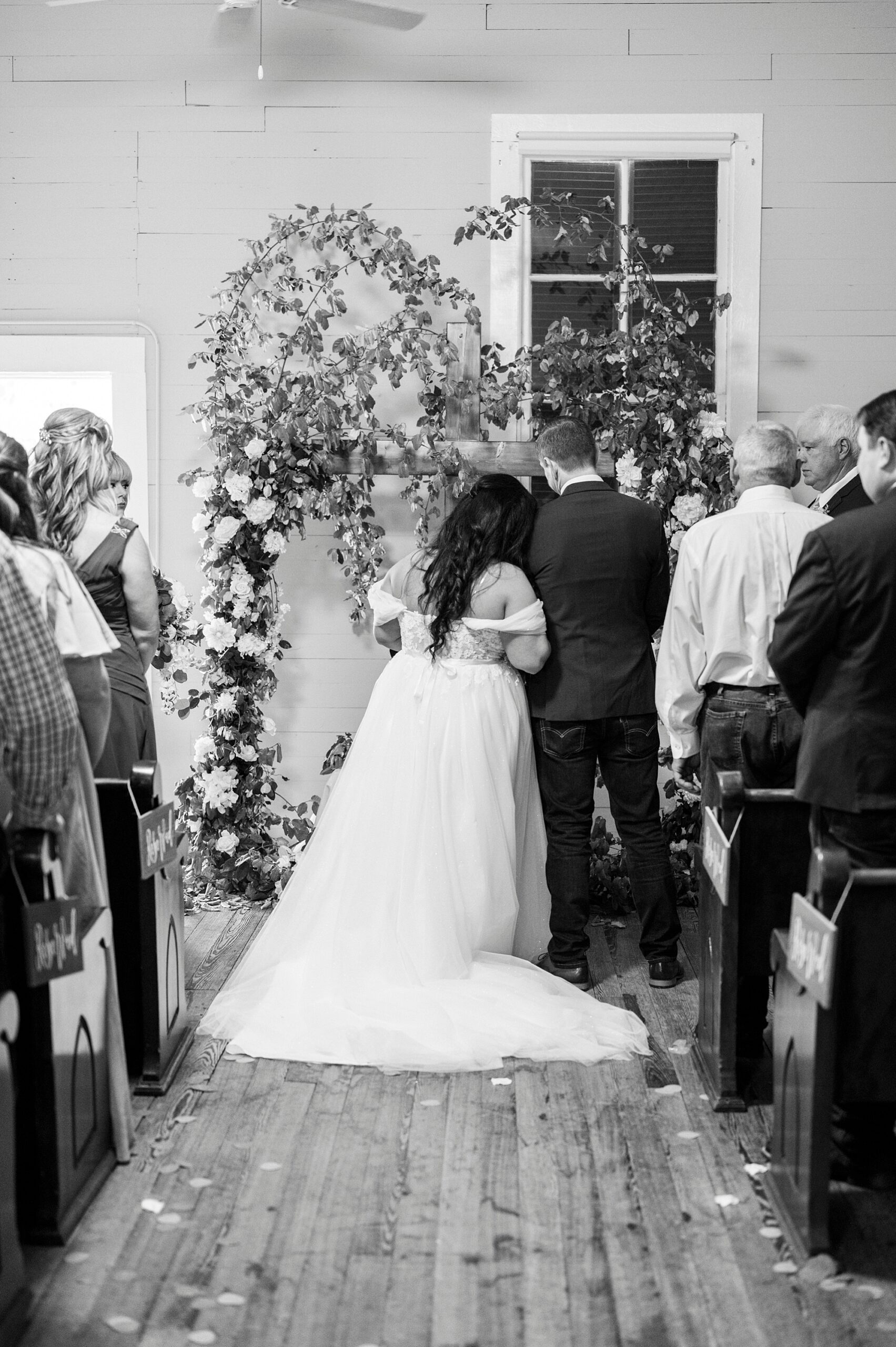 bride leans on groom's shoulder during Troutman Historical Cemetery chapel ceremony 