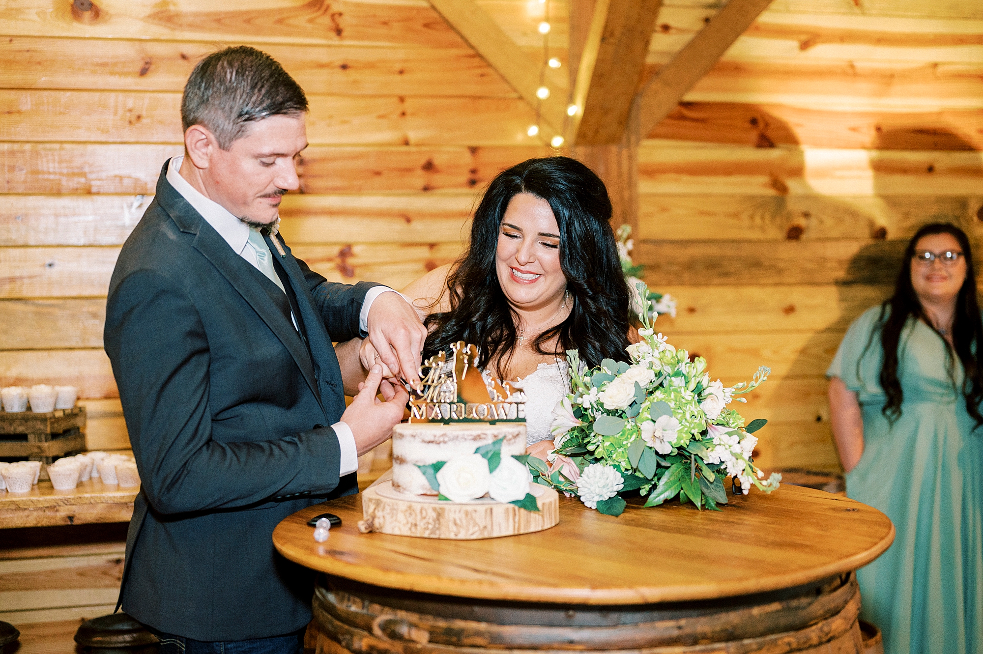 bride and groom cut cupcake during cake tasting 