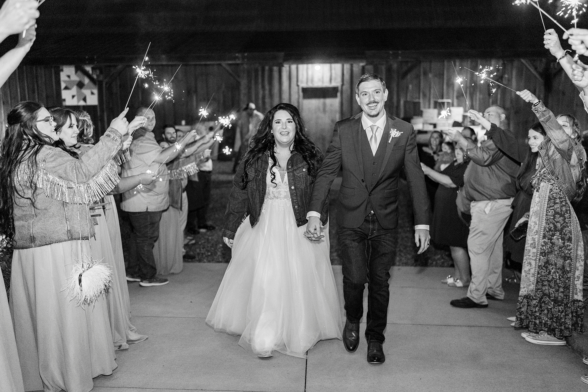 newlyweds leave wedding reception through sparkler exit