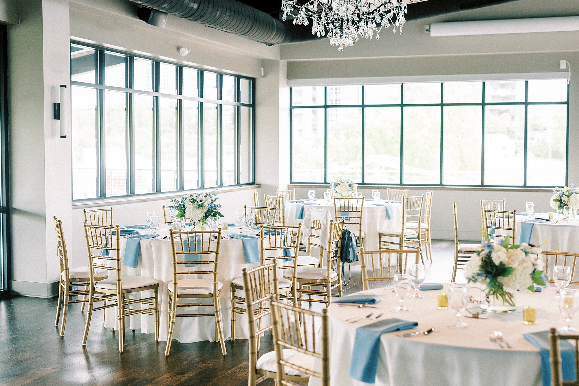 wedding reception inside the Terrace at Cedar Hill with pastel blue and white details