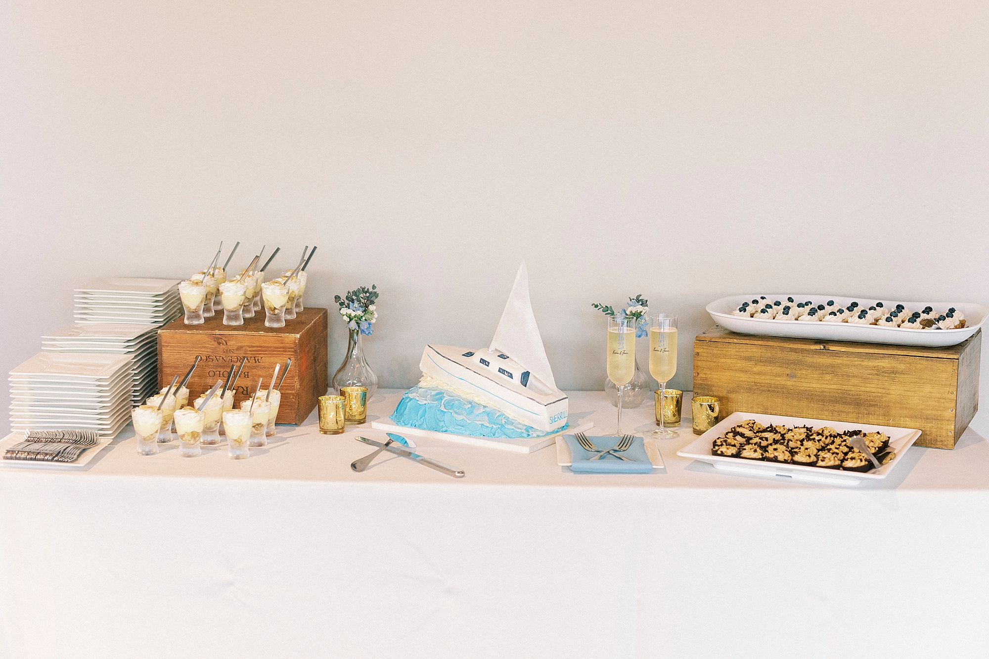 wedding cake in shape of boat with dessert display at the Terrace at Cedar Hill