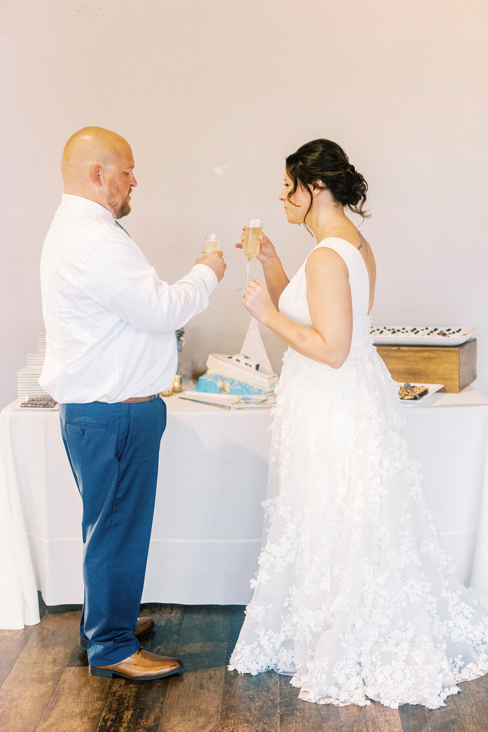 bride and groom feed each other desserts during reception 