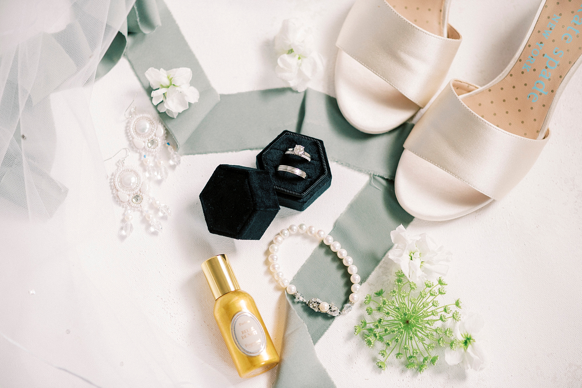 ivory shoes, mint green ribbon and rings in a black velvet box