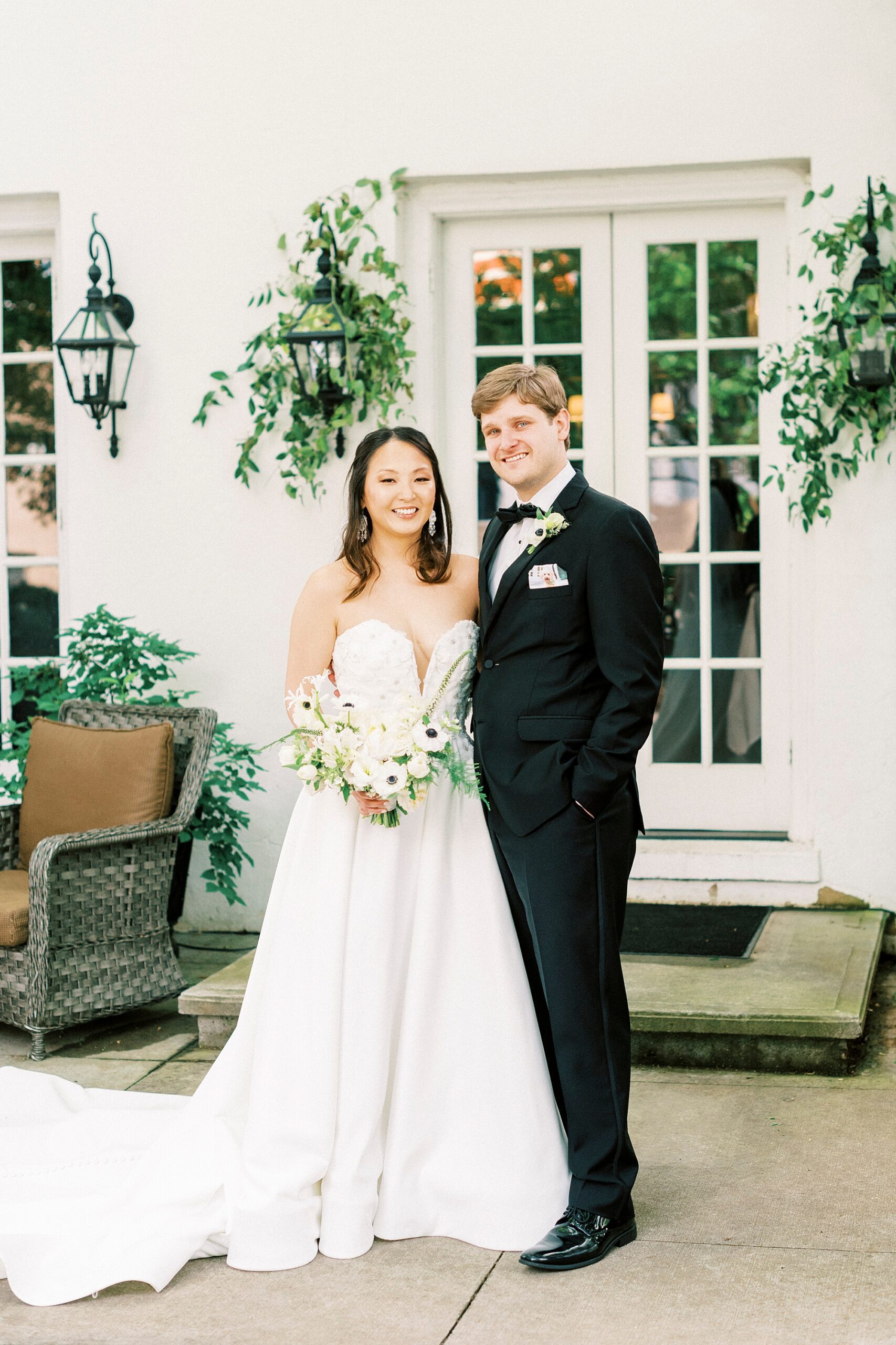 bride and groom stand together on patio at The Spring House