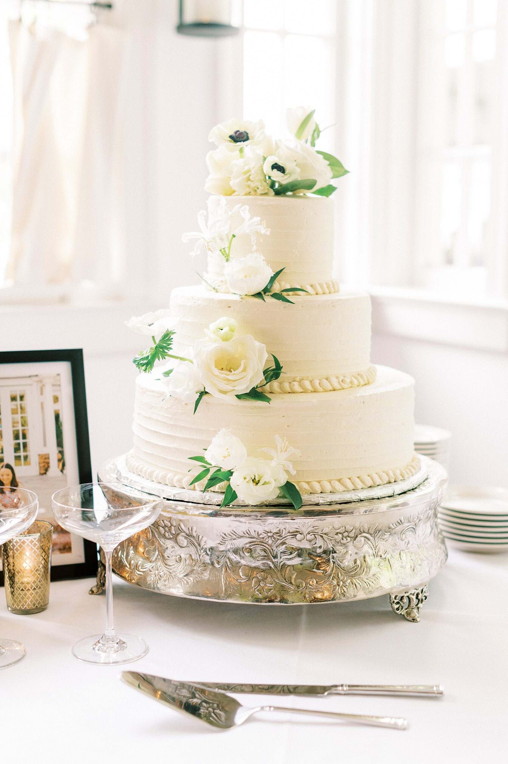 tiered wedding cake with ivory flowers at The Spring House