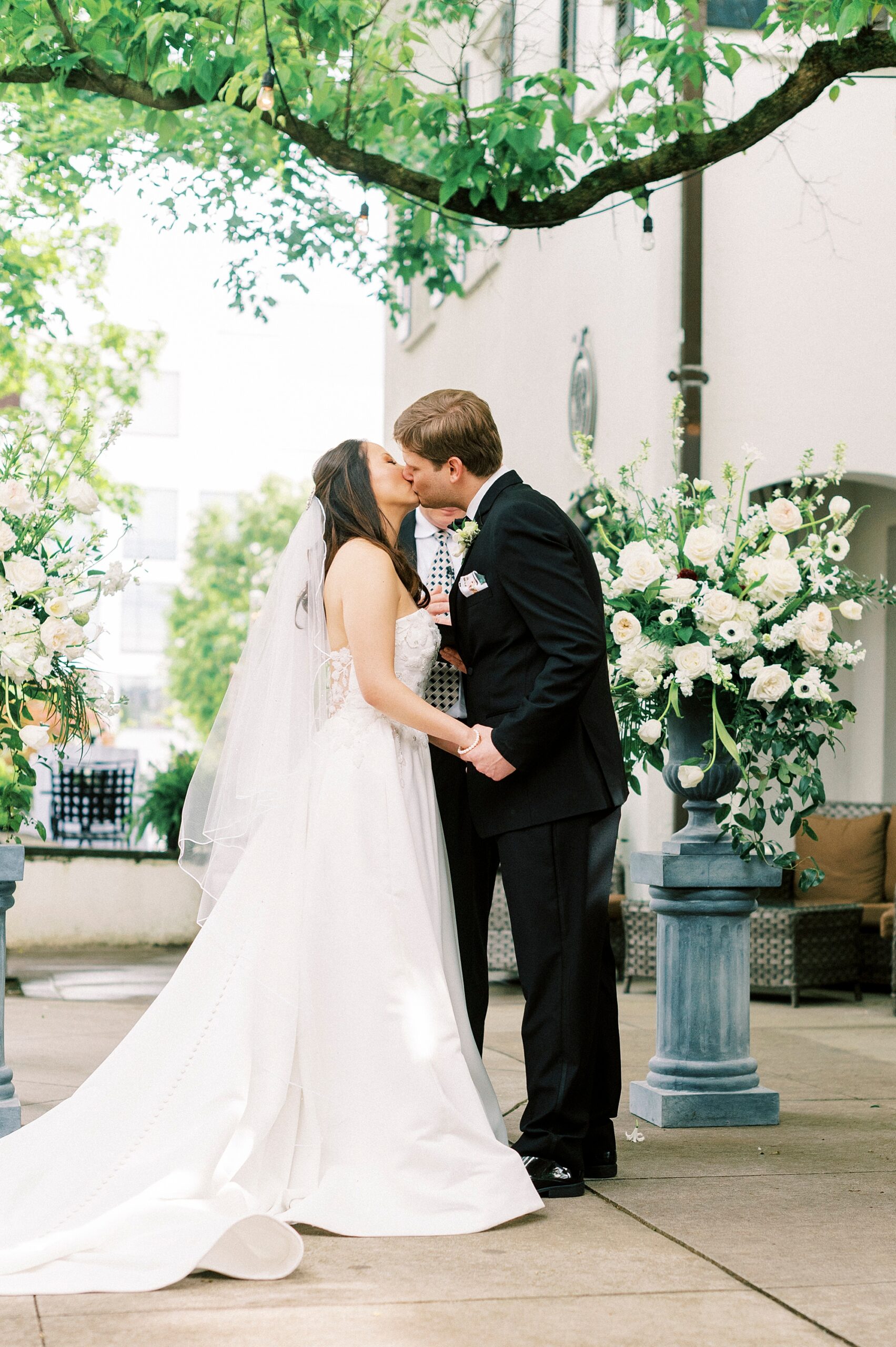 newlyweds lean for kiss during ceremony at The Spring House