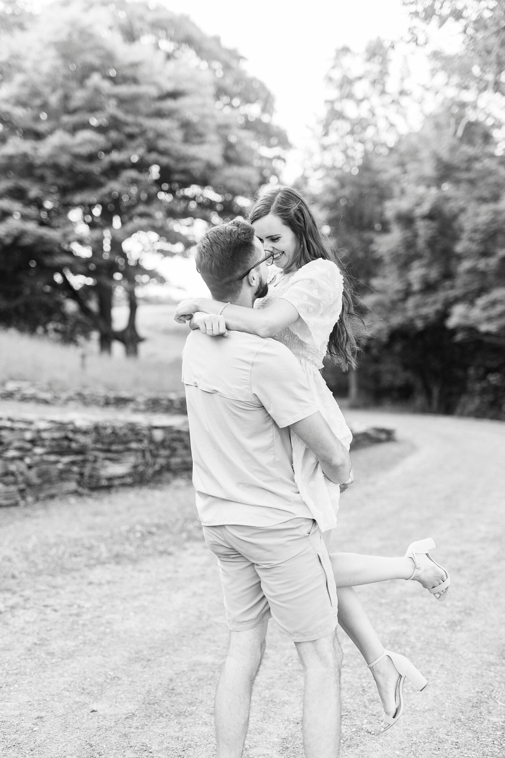 man lifts up fiancee during Blue Ridge Parkway Engagement Session