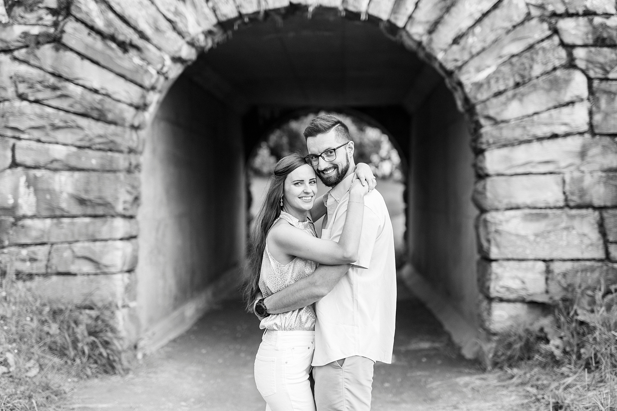 engaged couple hugs under stone tunnel during Blue Ridge Parkway engagement session
