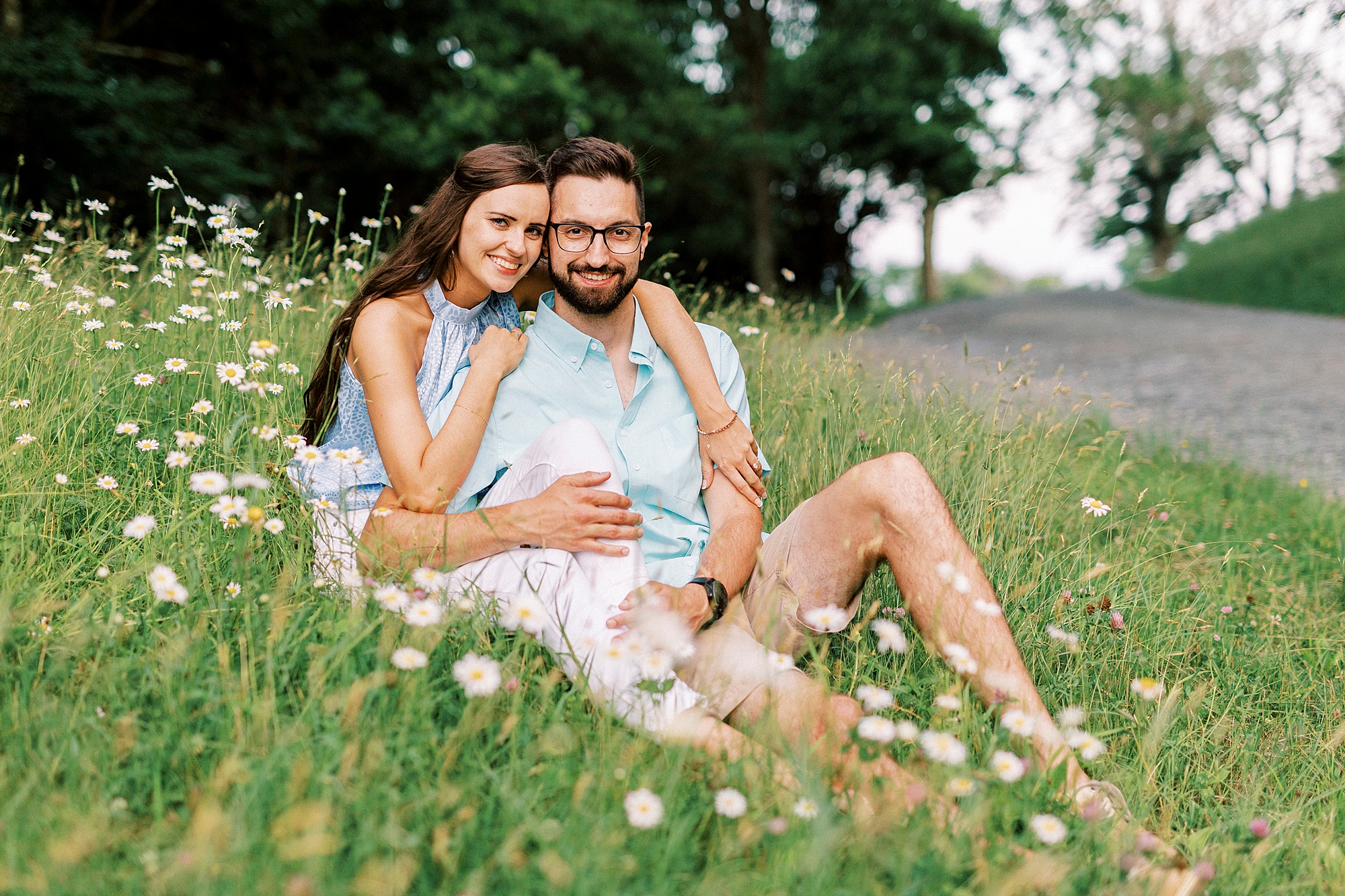 engaged couple sits on hill during Blue Ridge Parkway engagement session