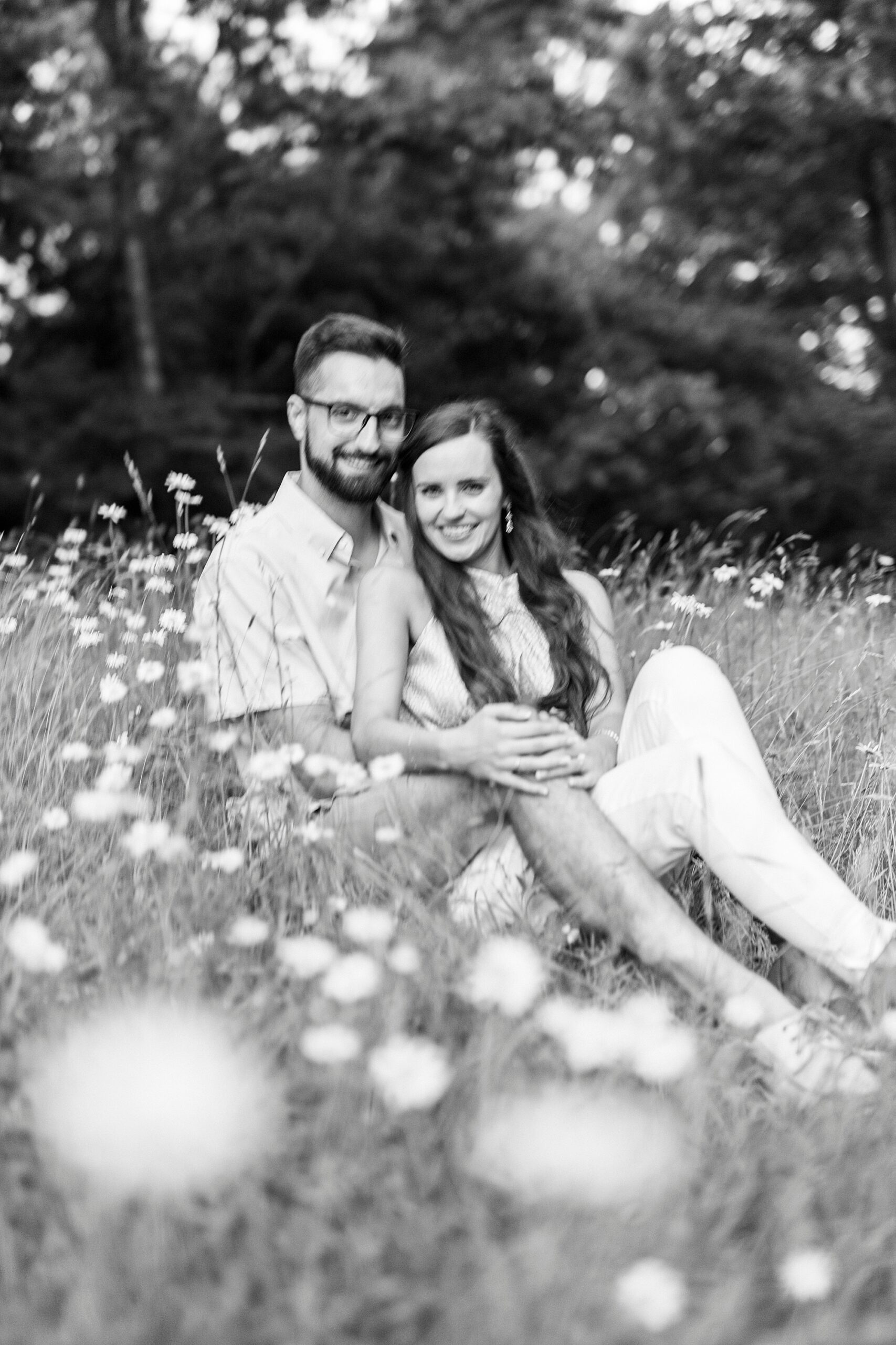 engaged couple sits together during Blue Ridge Parkway engagement session