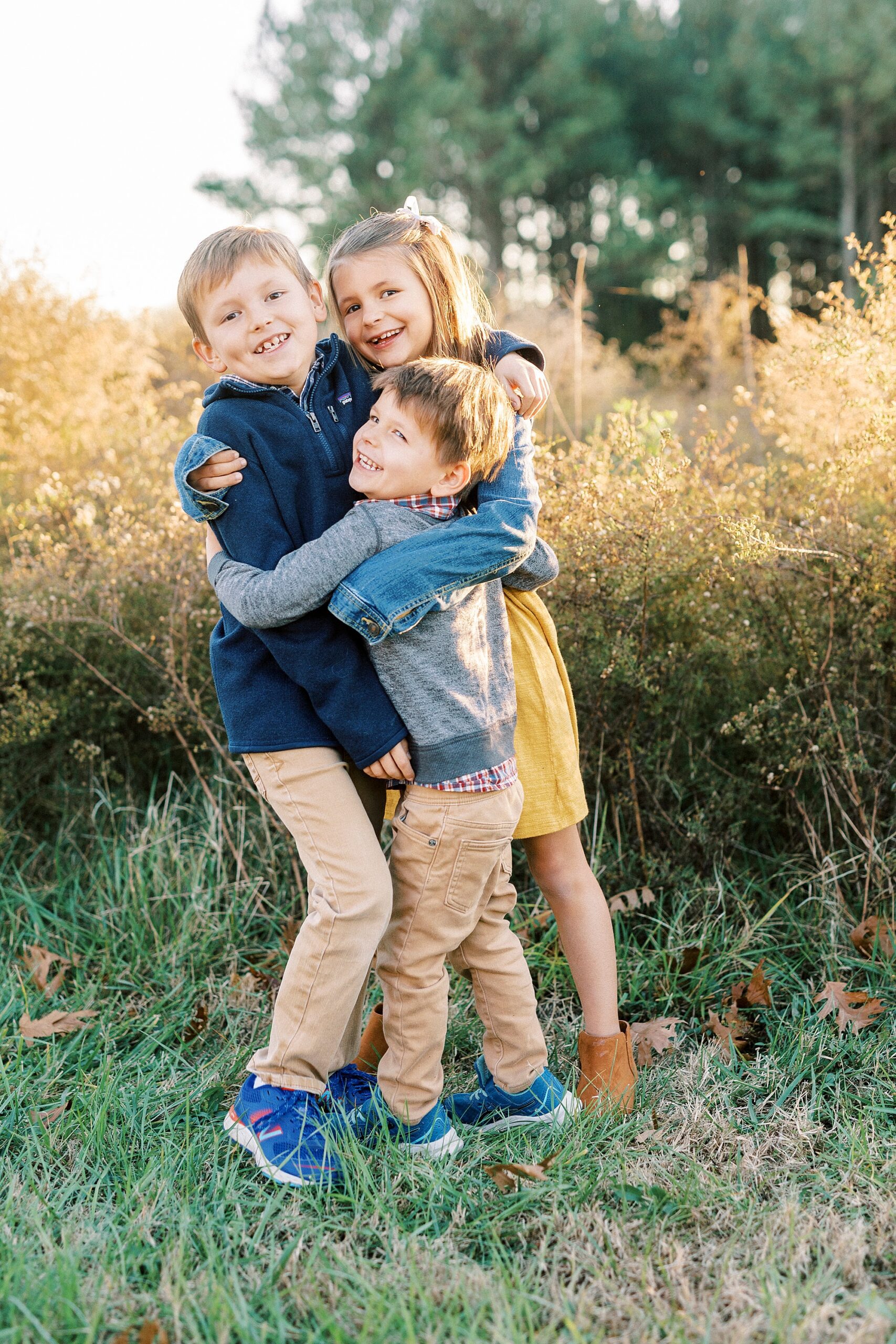 kids hug during fall family portraits at Frank Liske Park
