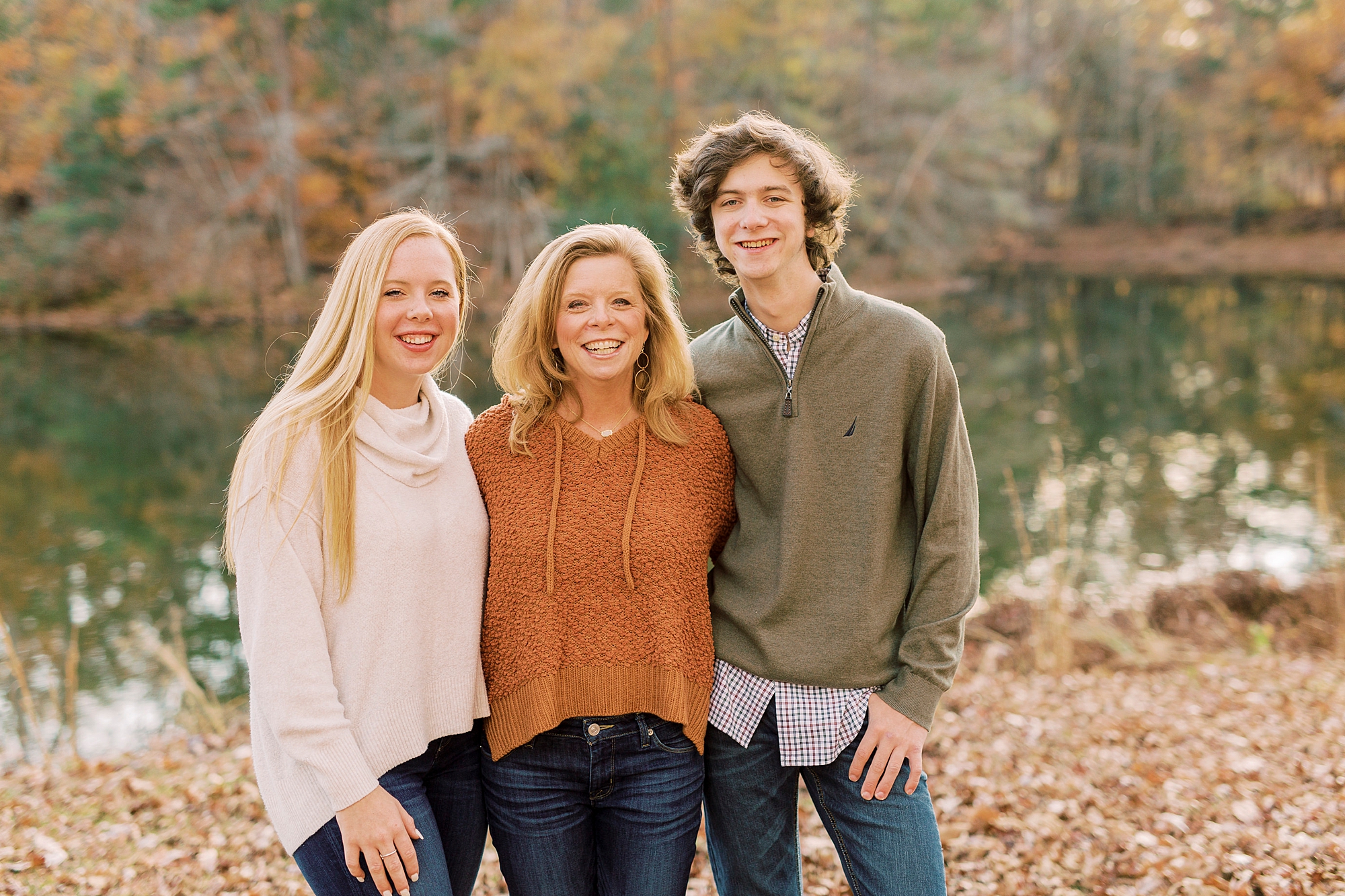 mom hugs two kids during fall photos in NC