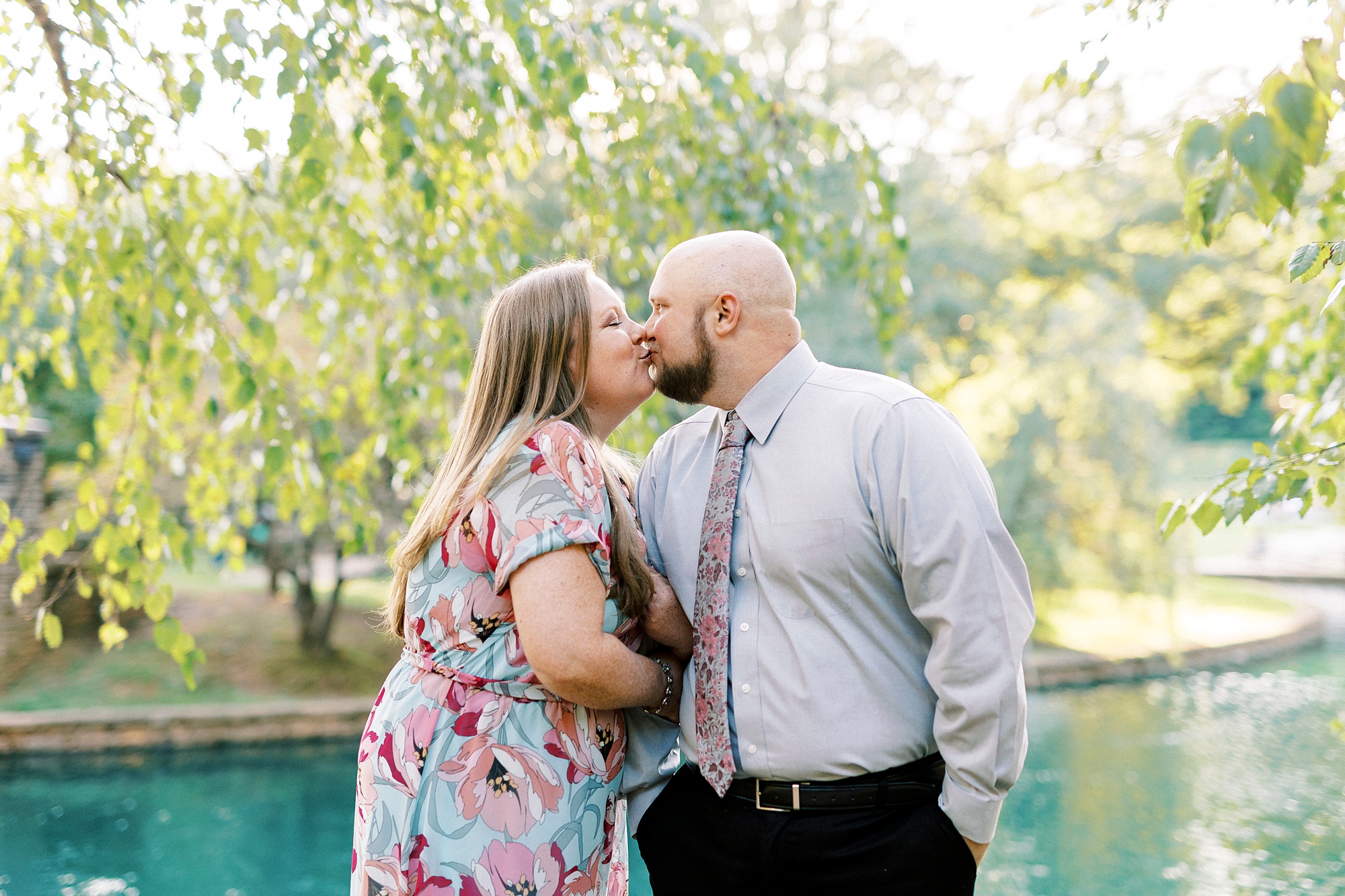 man kisses woman during spring engagement photos in Charlotte NC