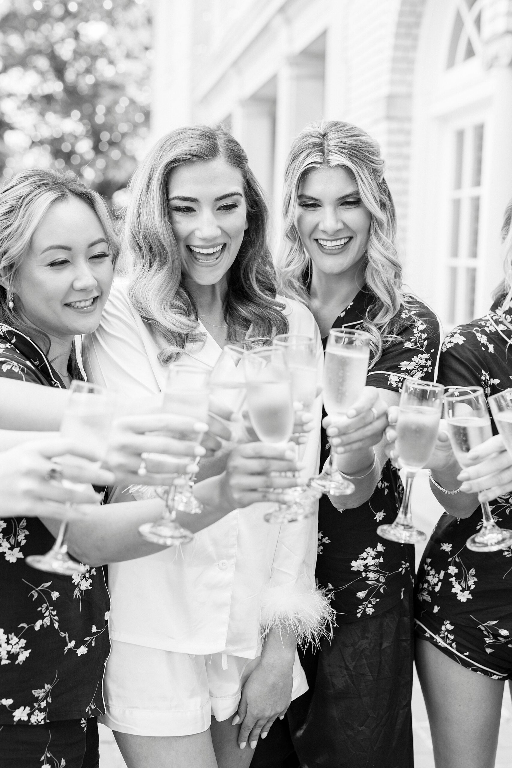 bride toasts champagne with bridesmaids in North Carolina 