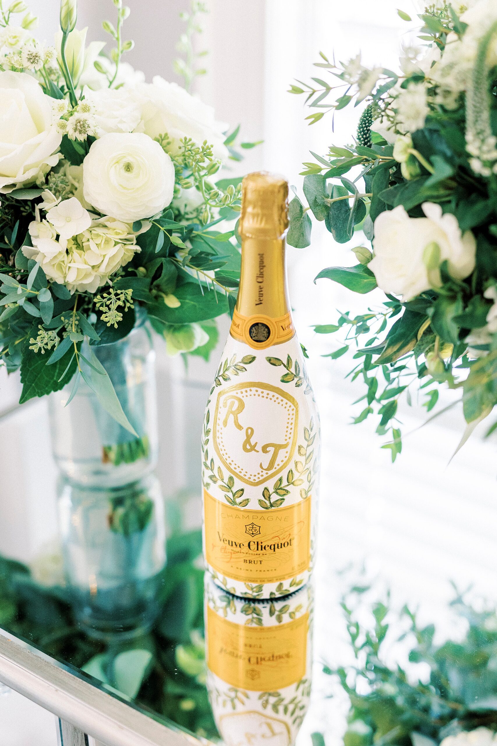 bottle of champagne between ivory flowers on table inside Separk Mansion