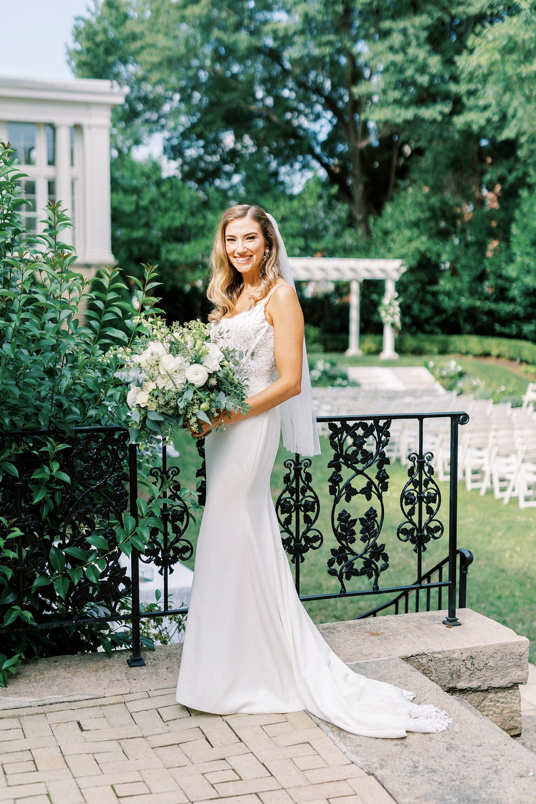 bride stands by patio with wrought iron railings at Separk Mansion