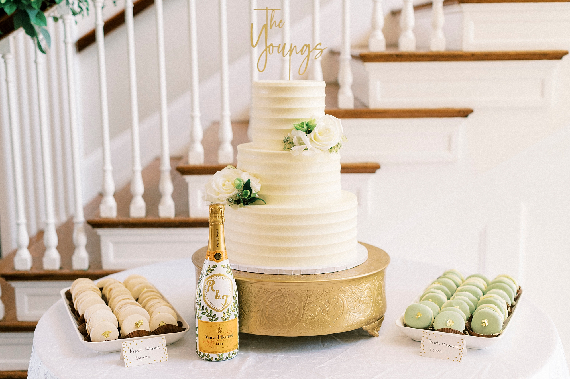 tiered wedding cake with ivory icing on gold platform inside Separk Mansion