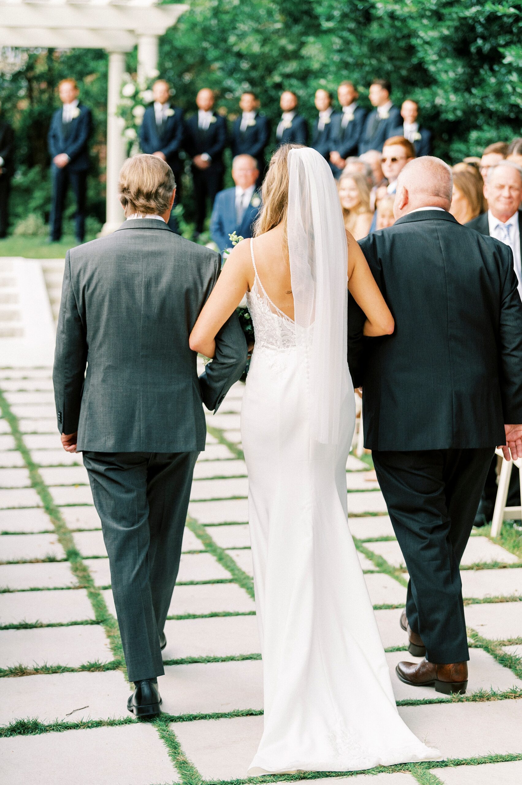 bride and father walk down aisle at Separk Mansion wedding ceremony 