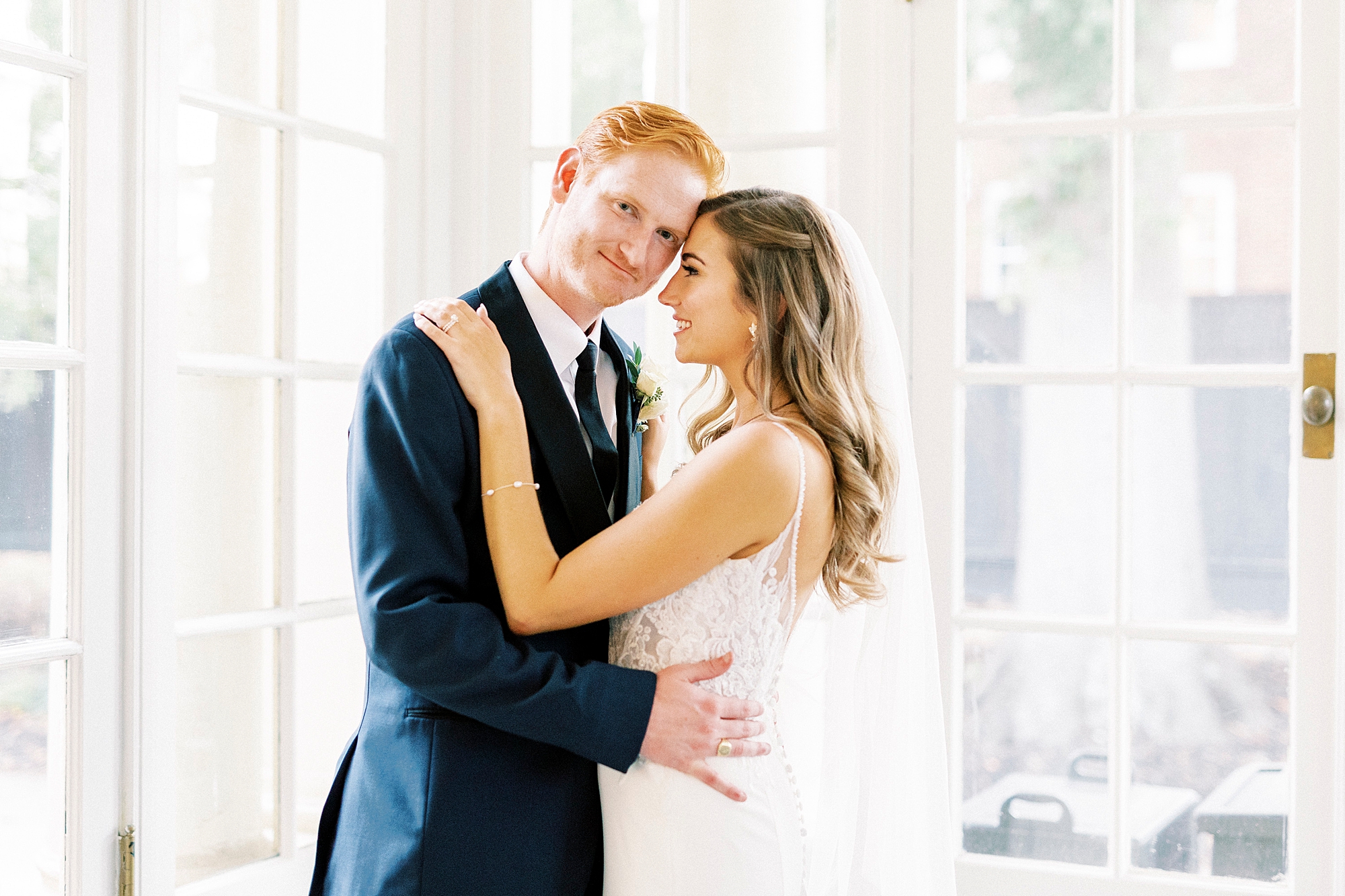 bride leans head into groom inside sunroom at Separk Mansion