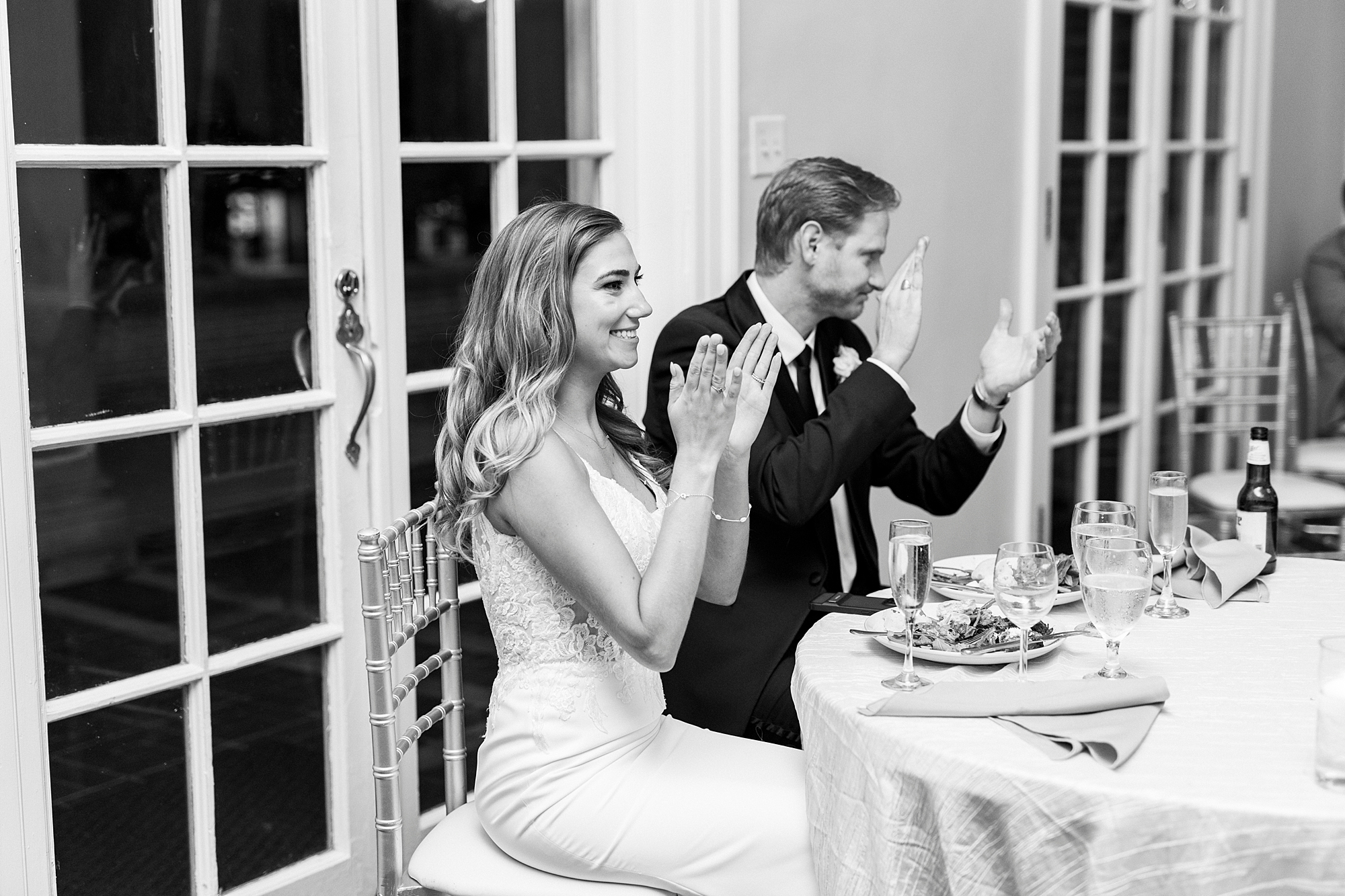 bride and groom clap during NC wedding reception