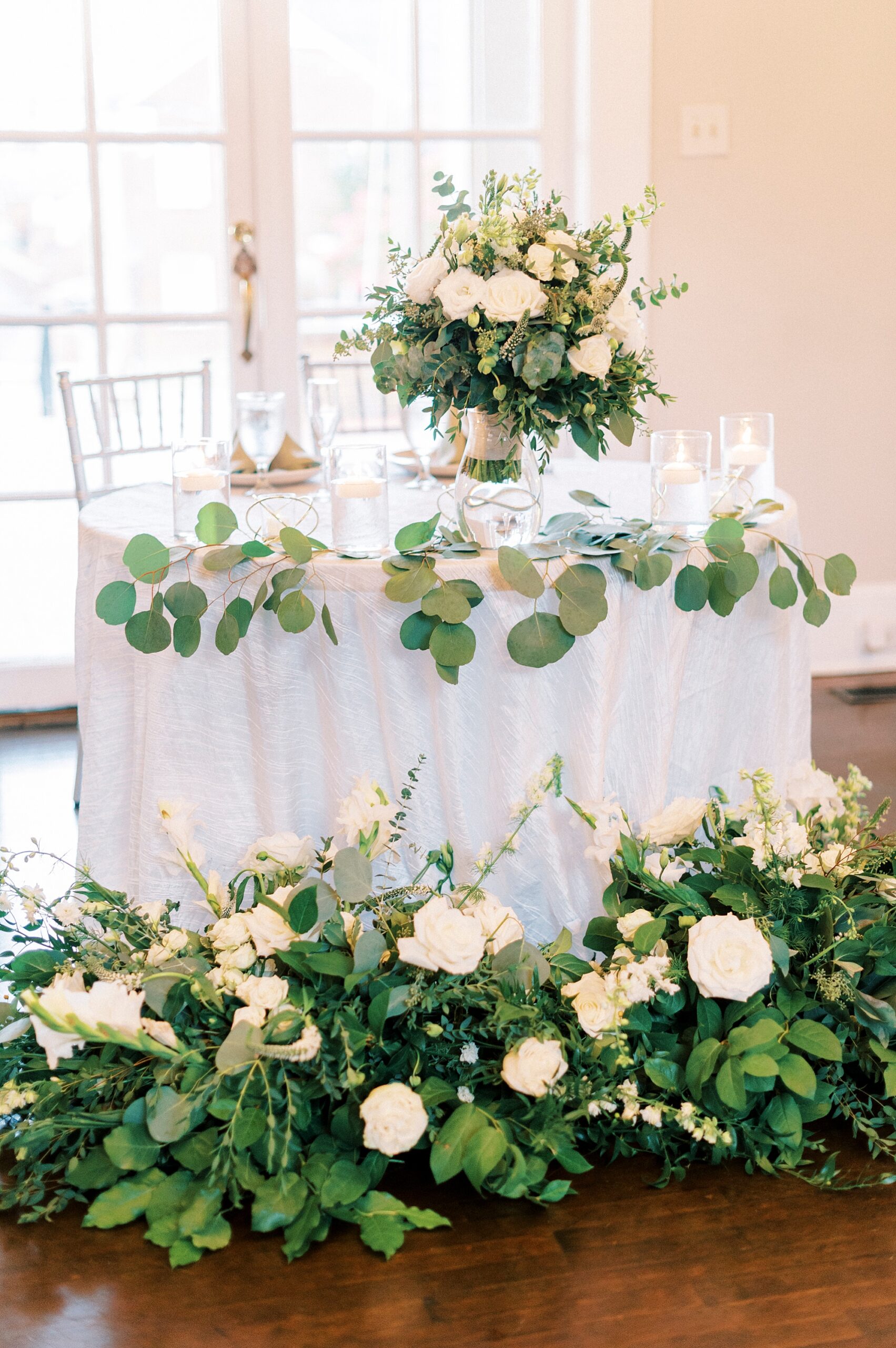 sweetheart table with greenery and ivory flowers at Separk Mansion 