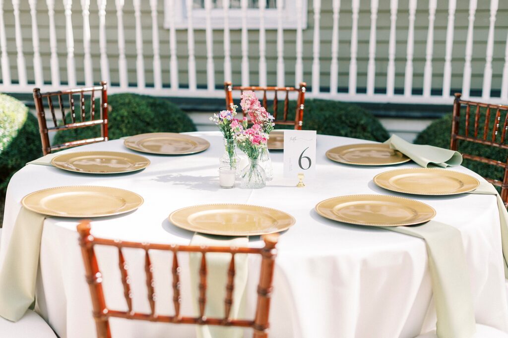 wedding reception place setting with gold plates