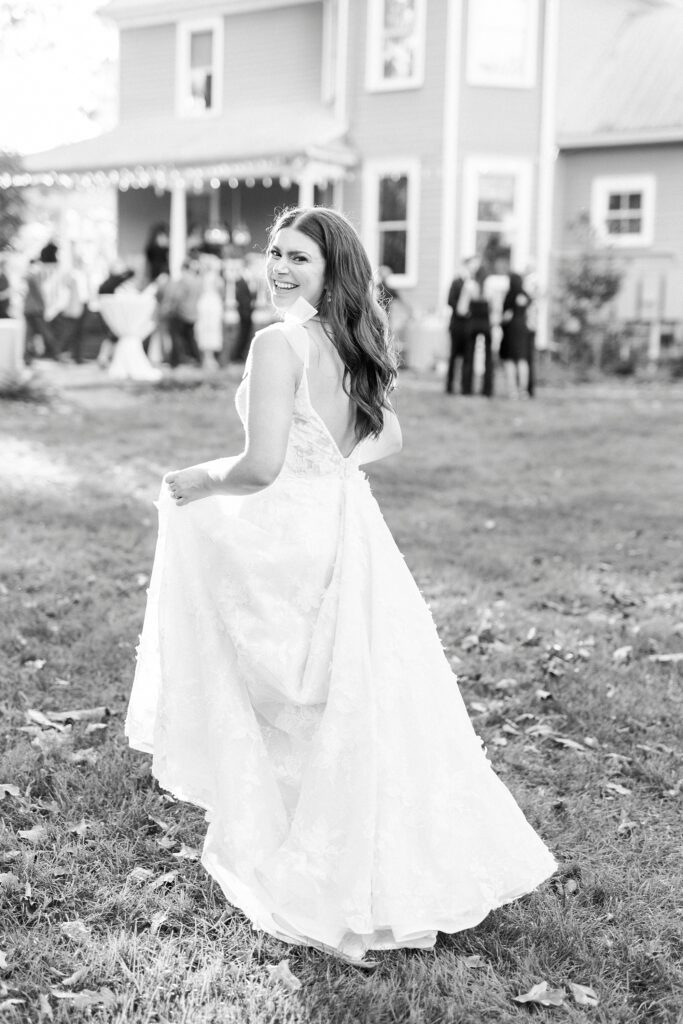 bride runs with wedding dress towards house at Whitehead Manor