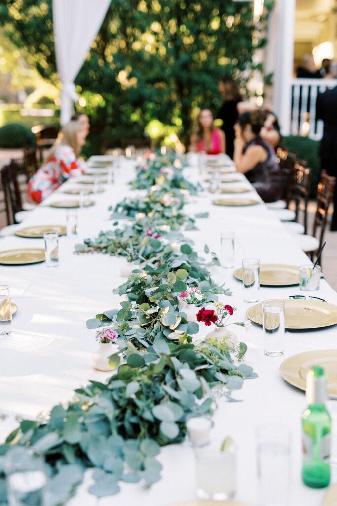 wedding reception table with greenery table runner