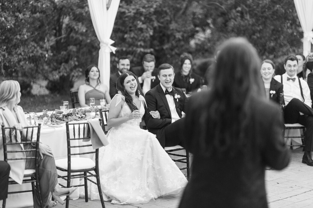 bride and groom clap during toasts in Charlotte NC