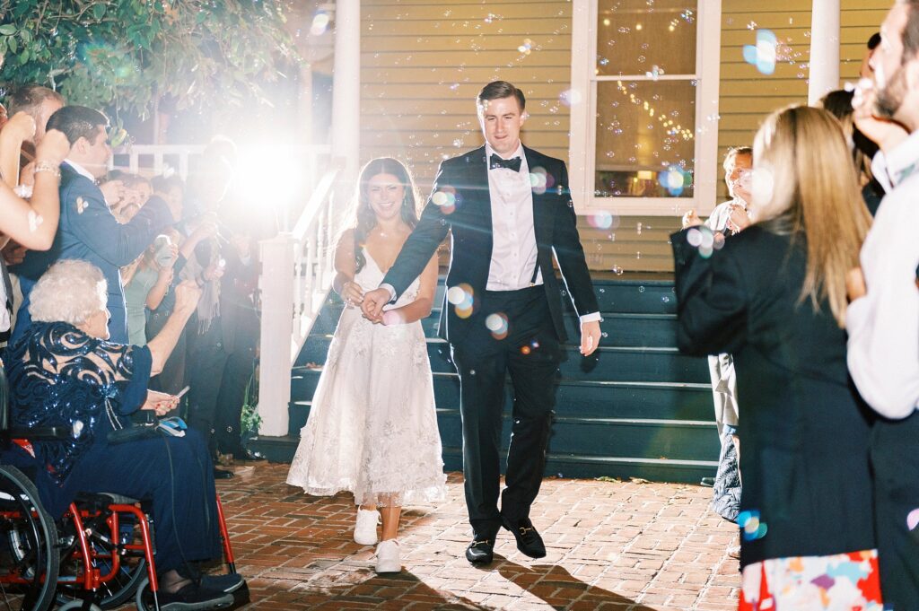 newlyweds walk down steps at Whitehead Manor for exit 