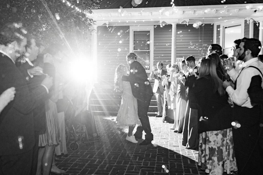 newlyweds dance during exit from wedding reception at Whitehead Manor