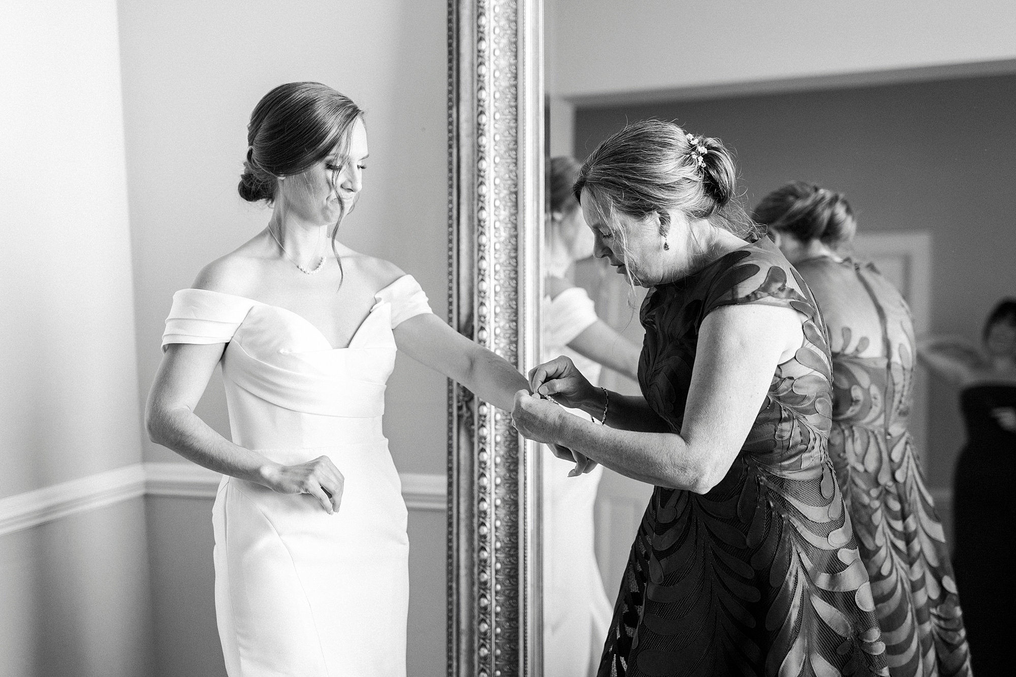 mother helps bride with bracelet before NC wedding day at Separk Mansion