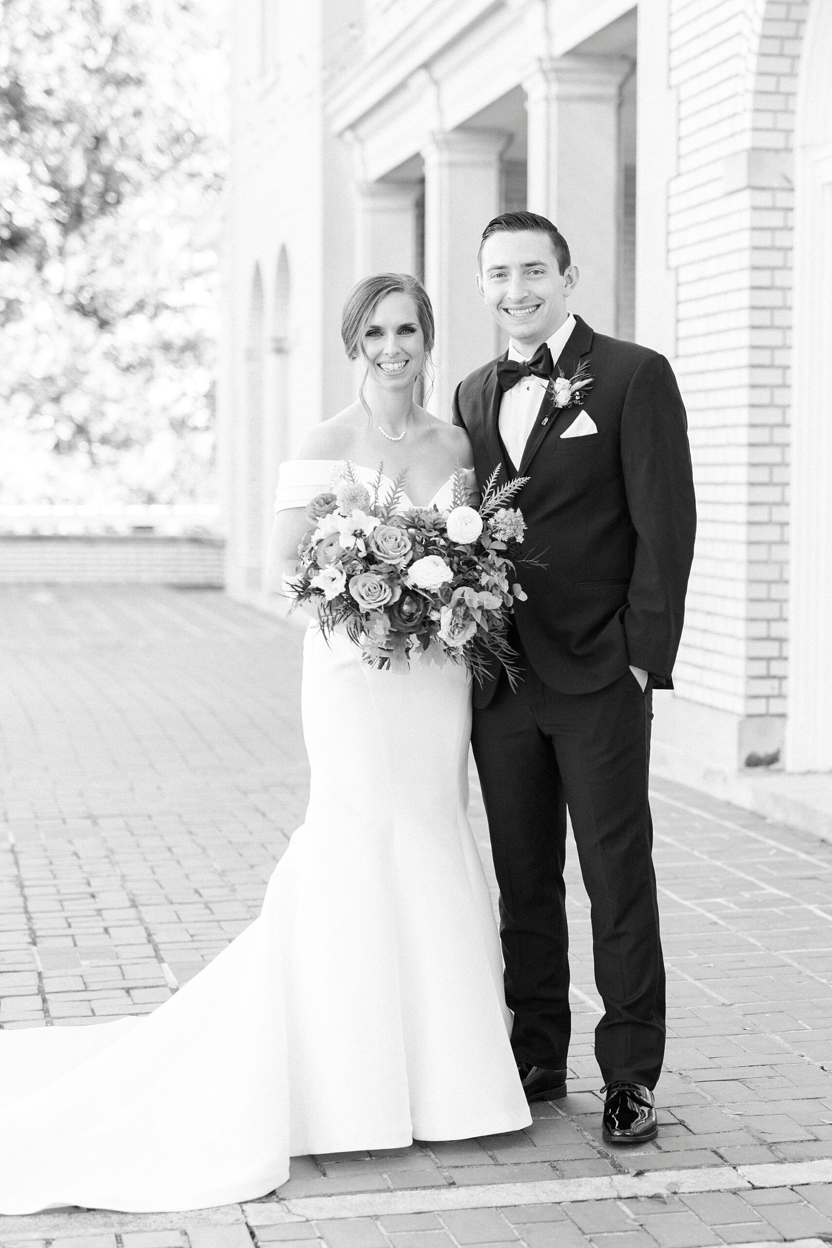 bride and groom stand on brick patio at Separk Mansion