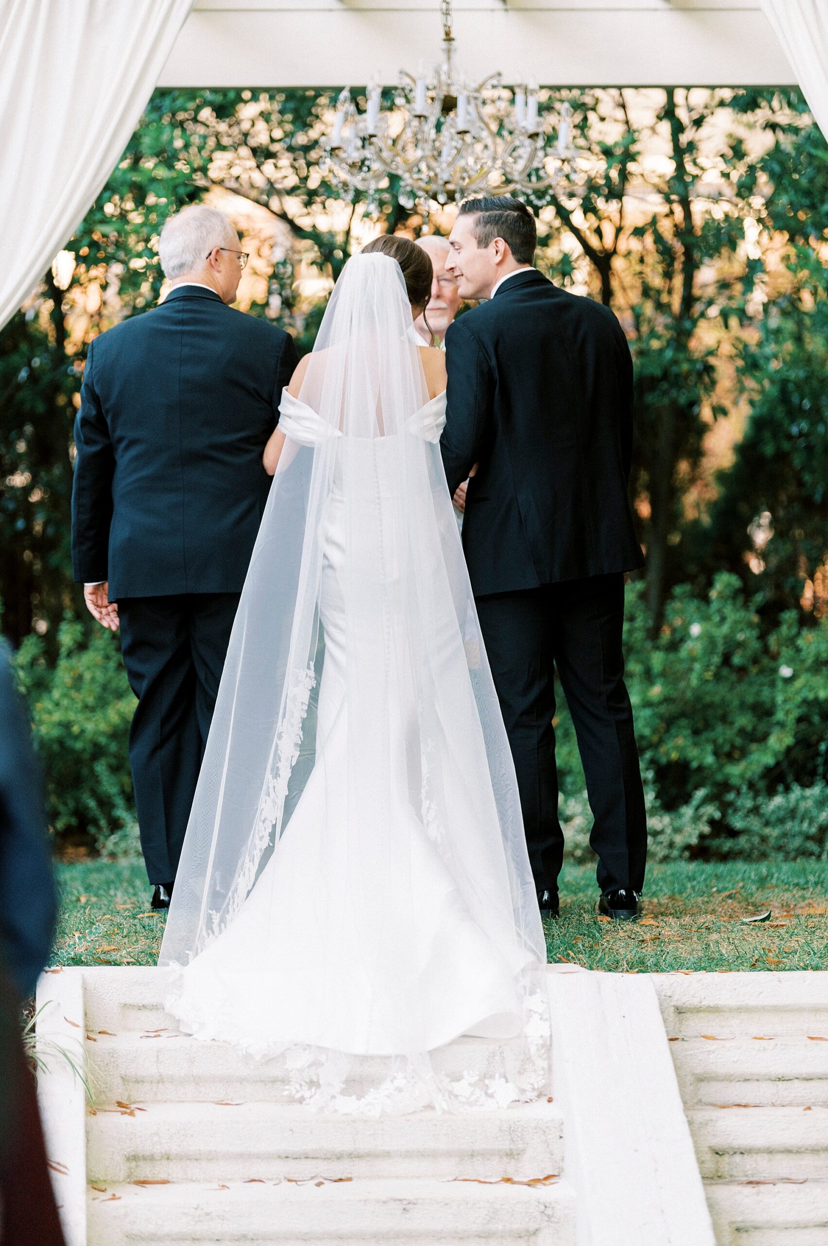 bride and groom stand under stone gazebo for ceremony at Separk Mansion