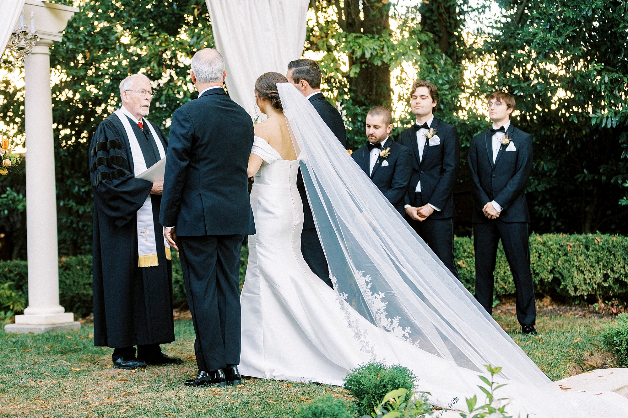 bride walks up aisle for outdoor ceremony at Separk Mansion