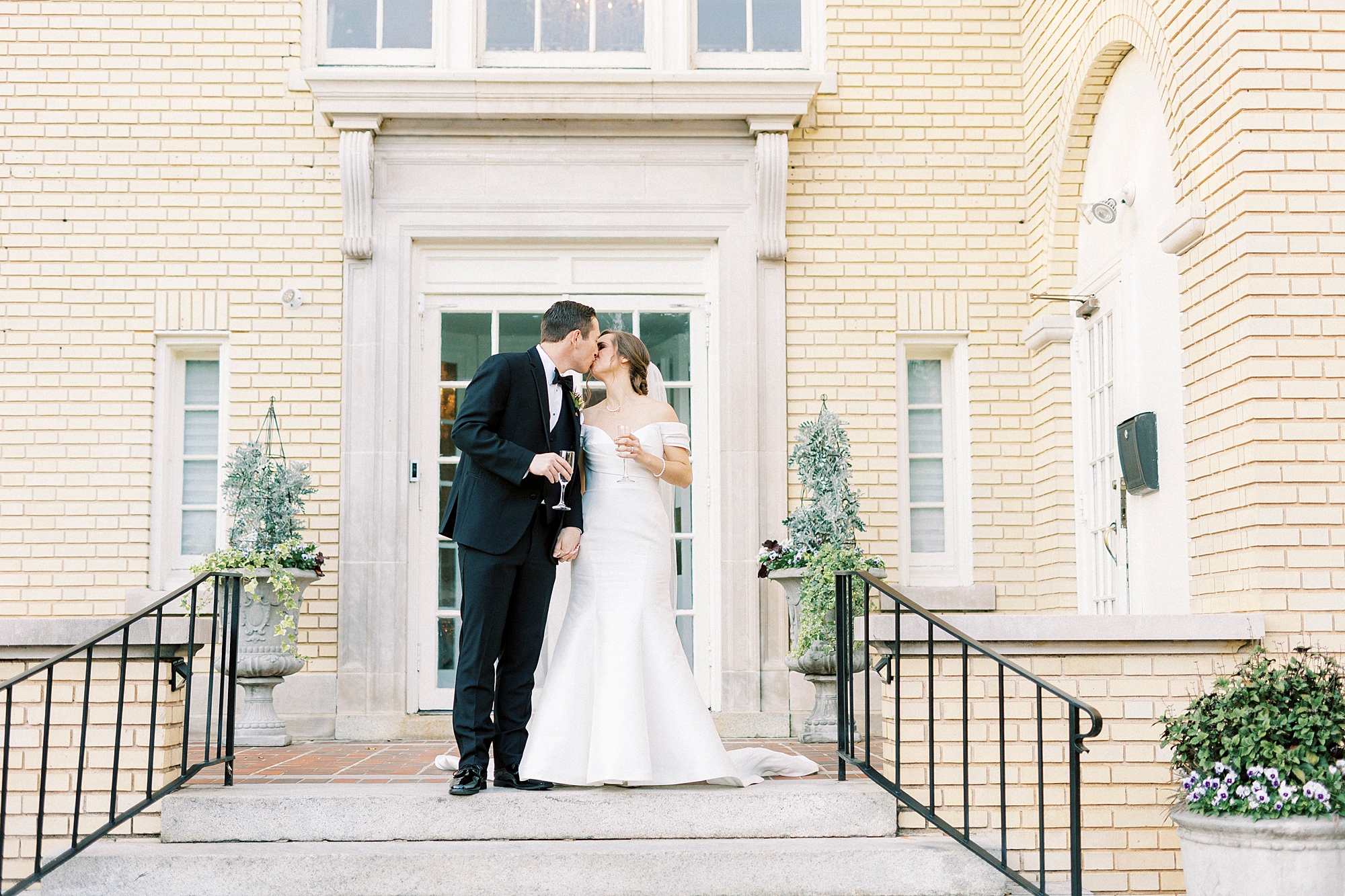 bride and groom kiss on steps at Separk Mansion