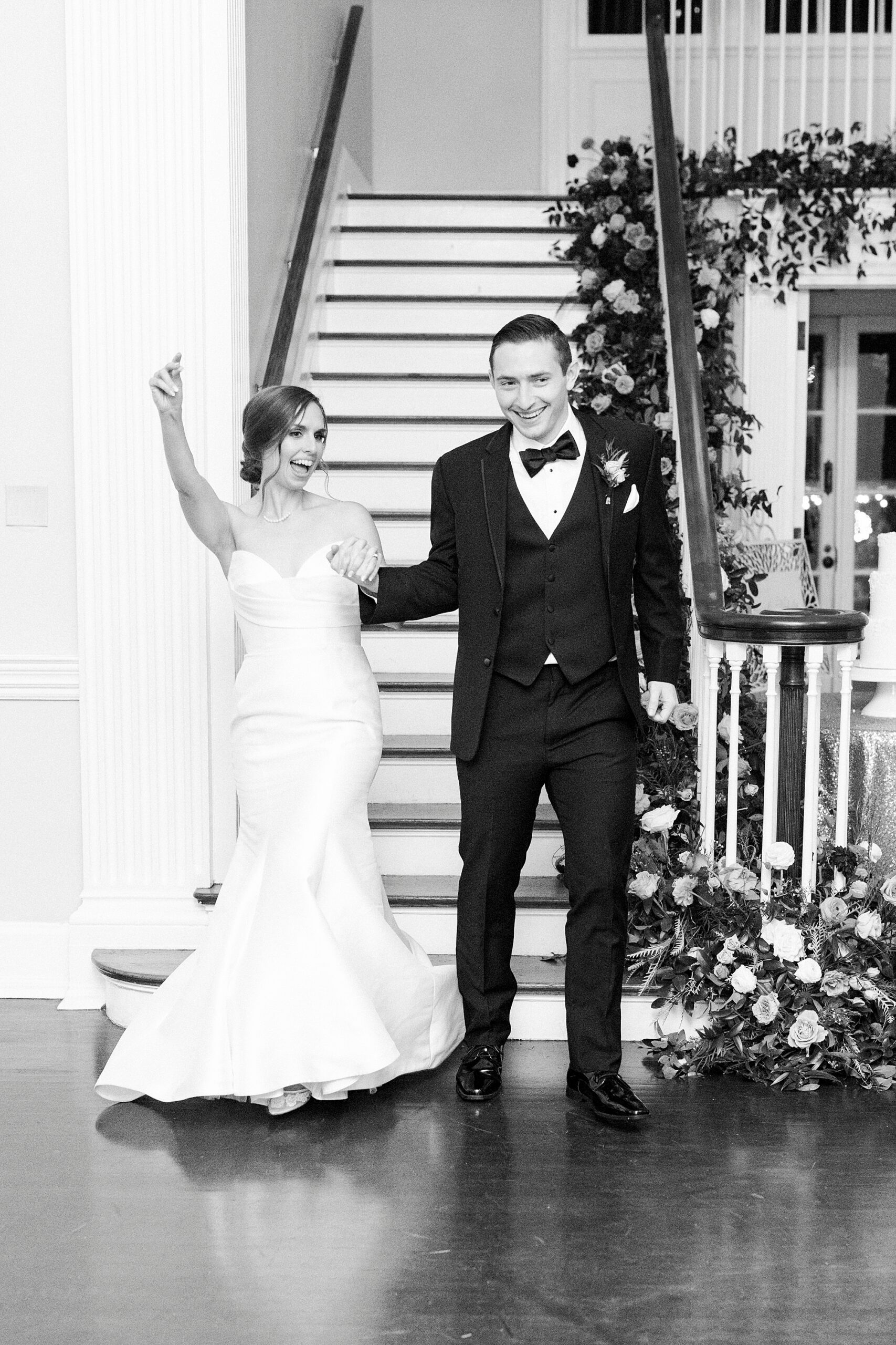 newlyweds cheer walking down steps for wedding reception at Separk Mansion