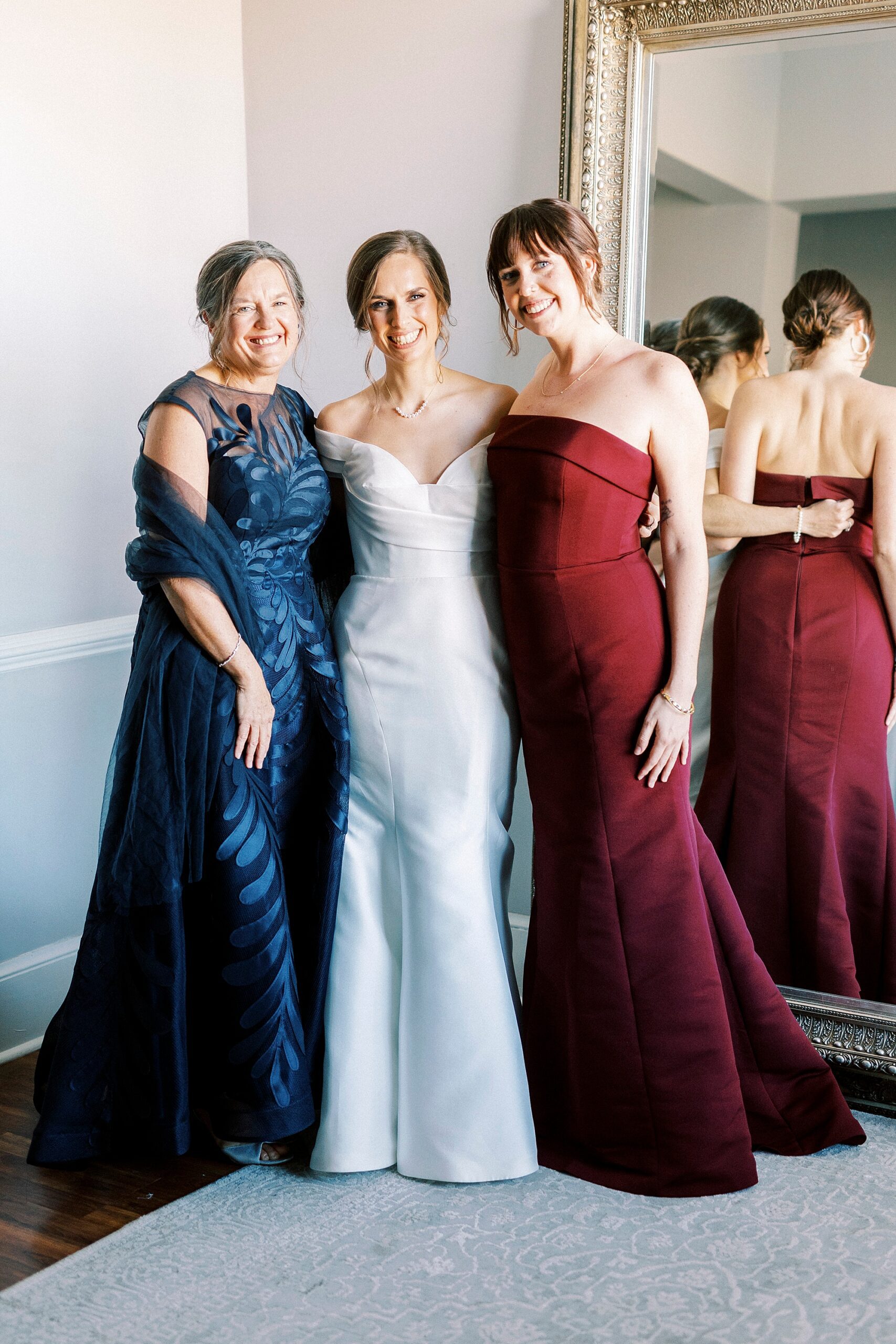 bride poses with mother and sister inside the Separk Mansion bridal suite