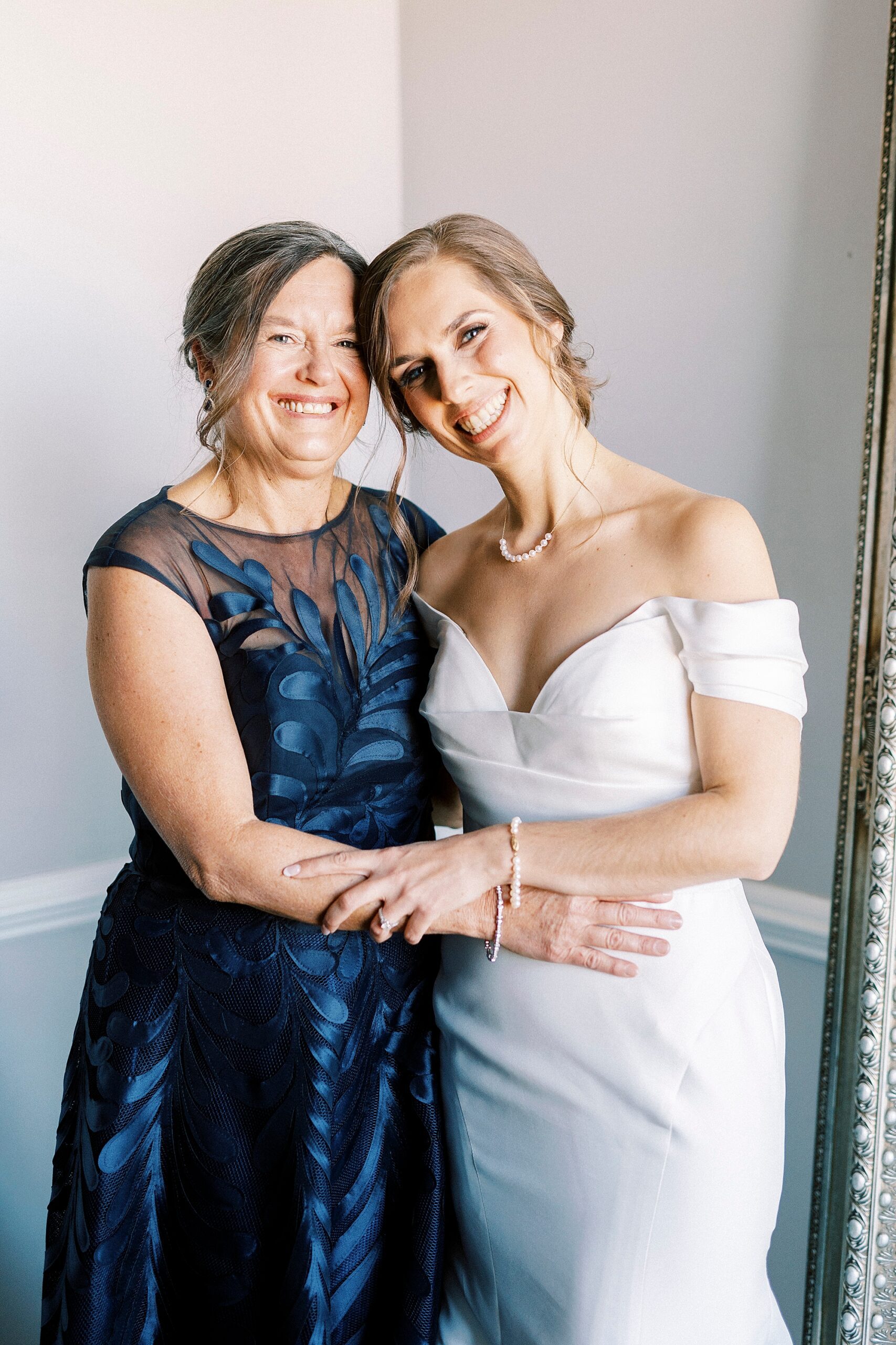 bride and mother hug inside the Separk Mansion bridal suite