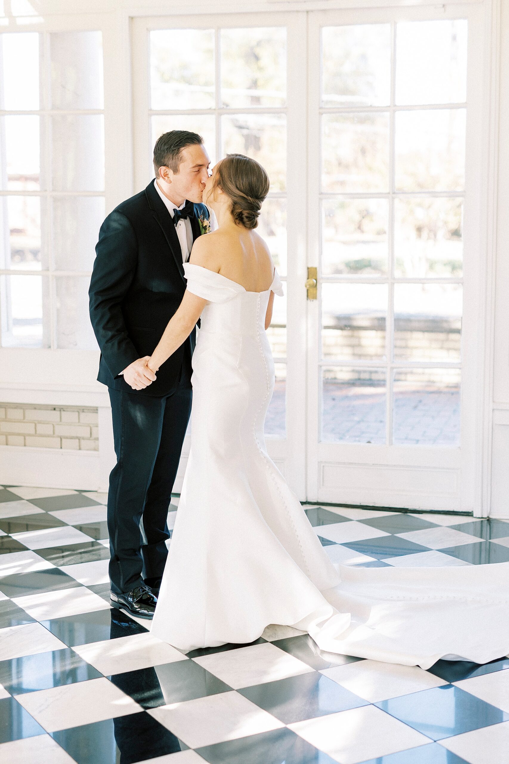 bride and groom kiss in sunroom at Separk Mansion