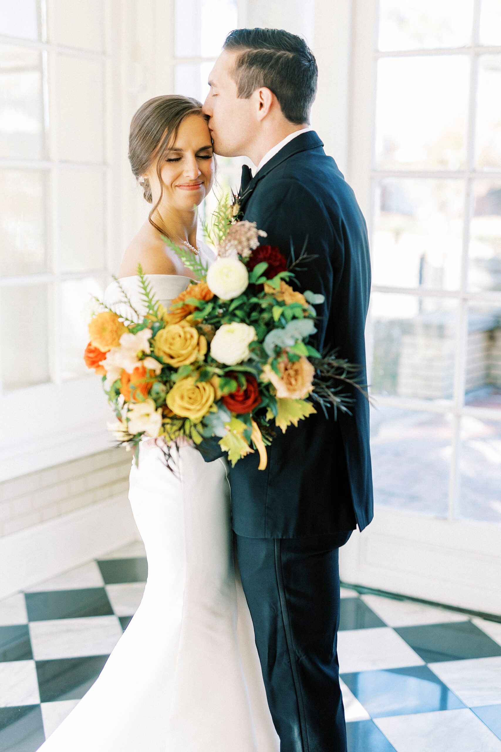 groom kisses bride's cheek during NC wedding day at Separk Mansion