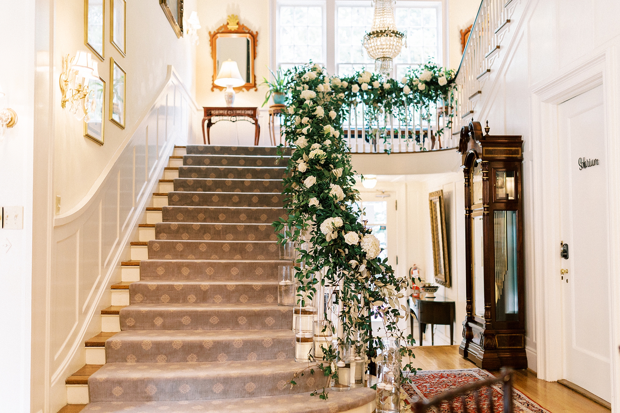 white flowers line staircase inside the Morehead Inn