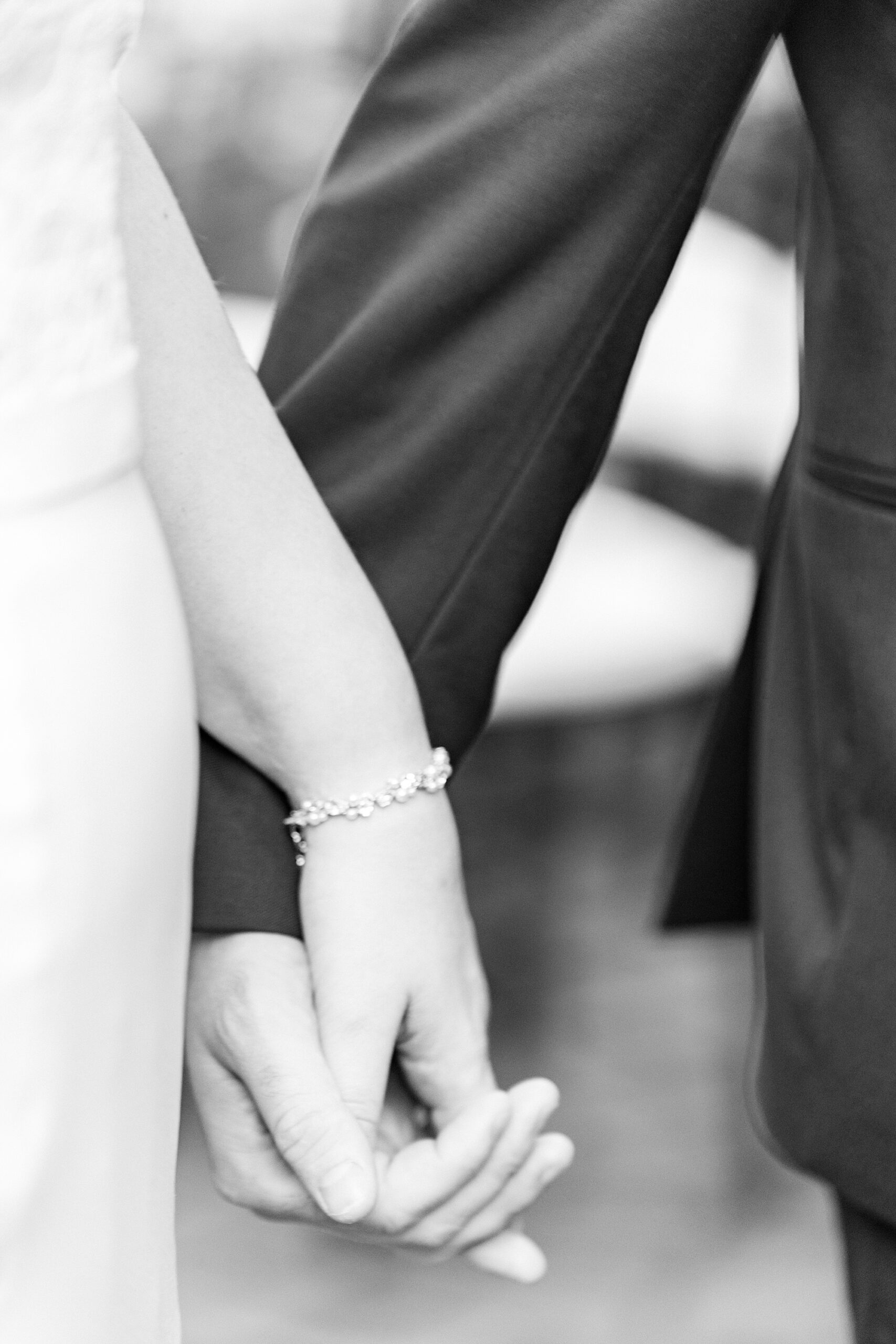 bride and groom hold hands during fall wedding day