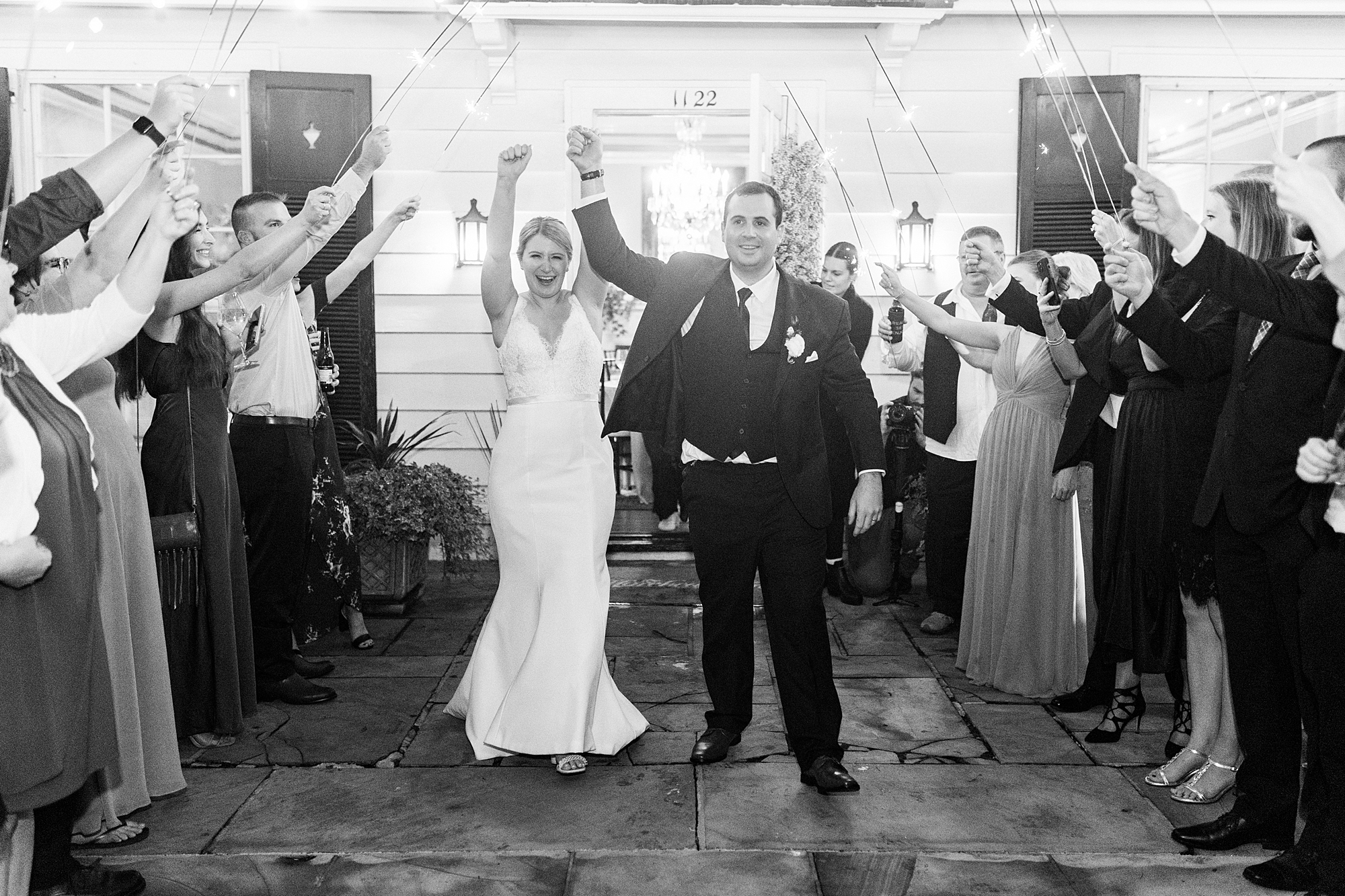 bride and groom leave the Morehead Inn through sparklers