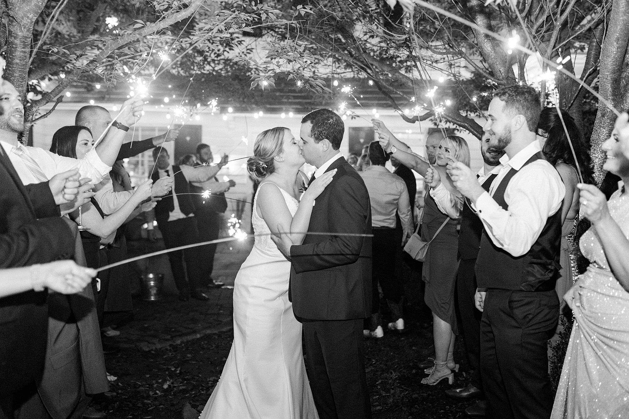bride and groom kiss during sparkler exit at the Morehead Inn